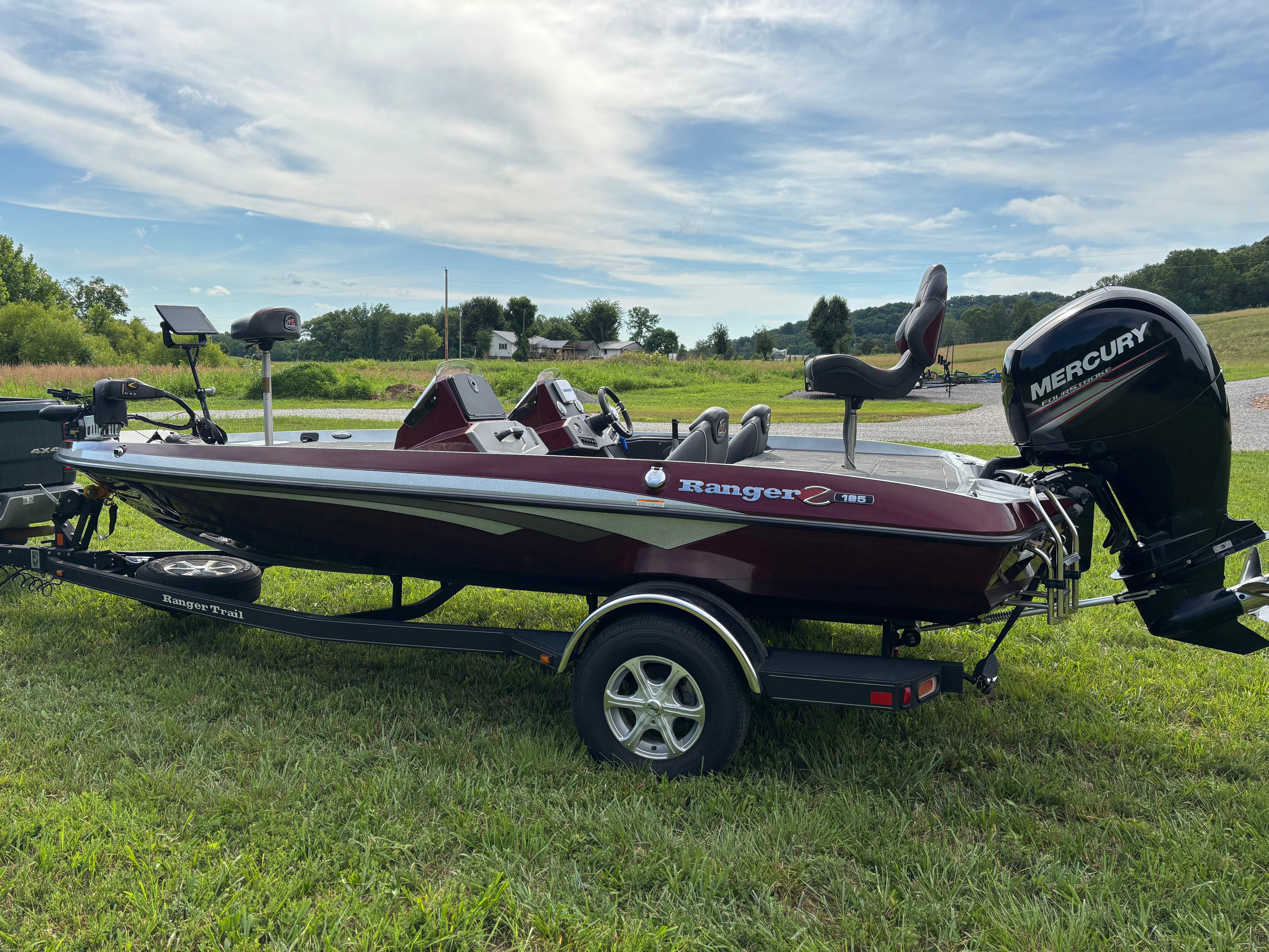 A 2016 Ranger Z 185 boat on a trailer in a grassy area.