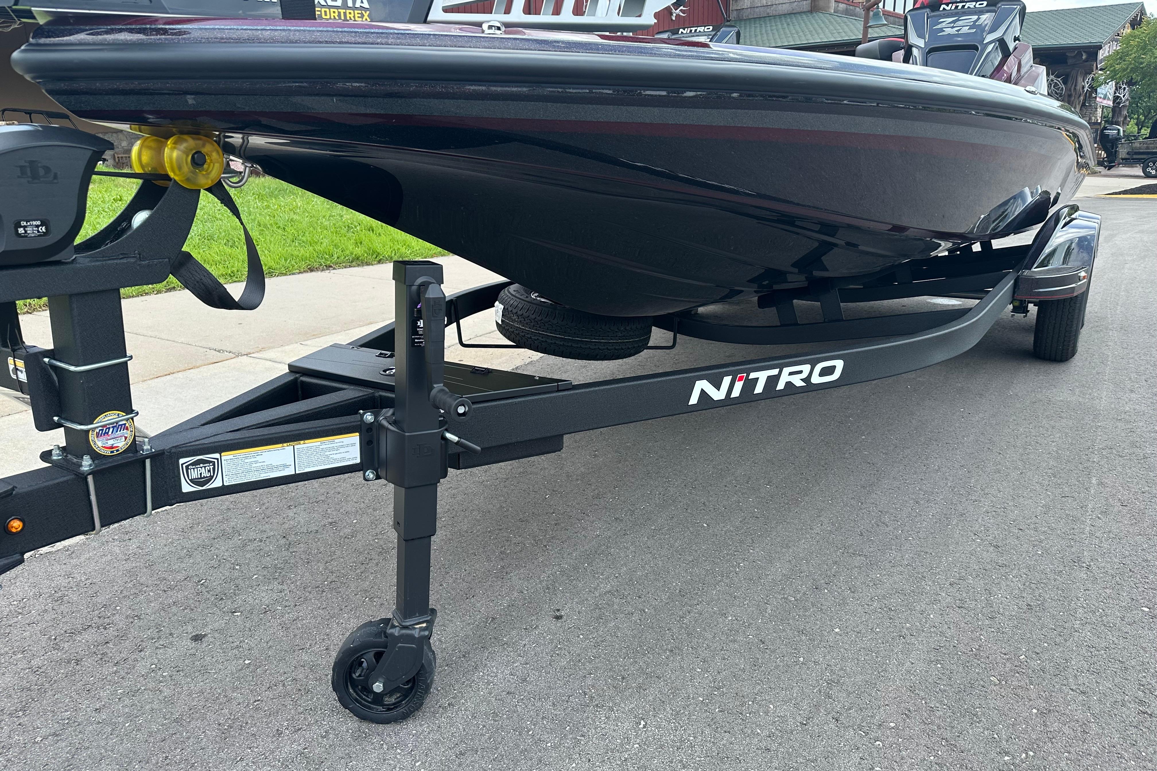 2026 Nitro Z21 XL boat on trailer, parked on a paved road.