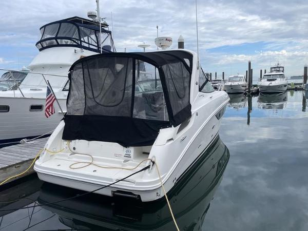2014 Sea Ray 310 Sundancer docked at marina with other boats.