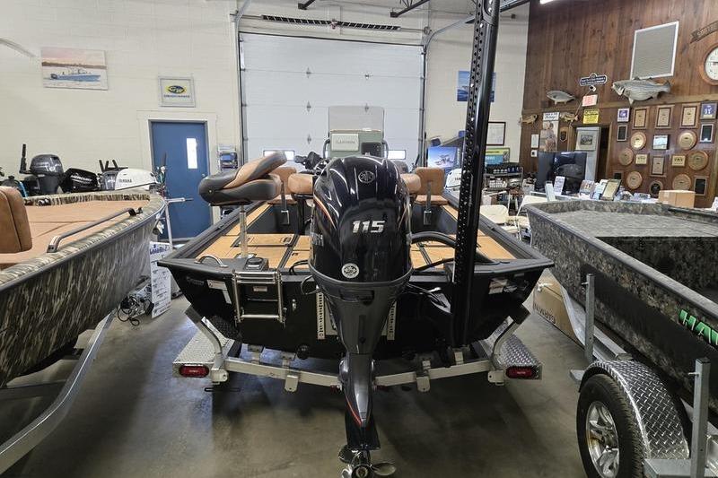 2026 Avid 207 Recon boat with 115 HP engine in showroom setting.