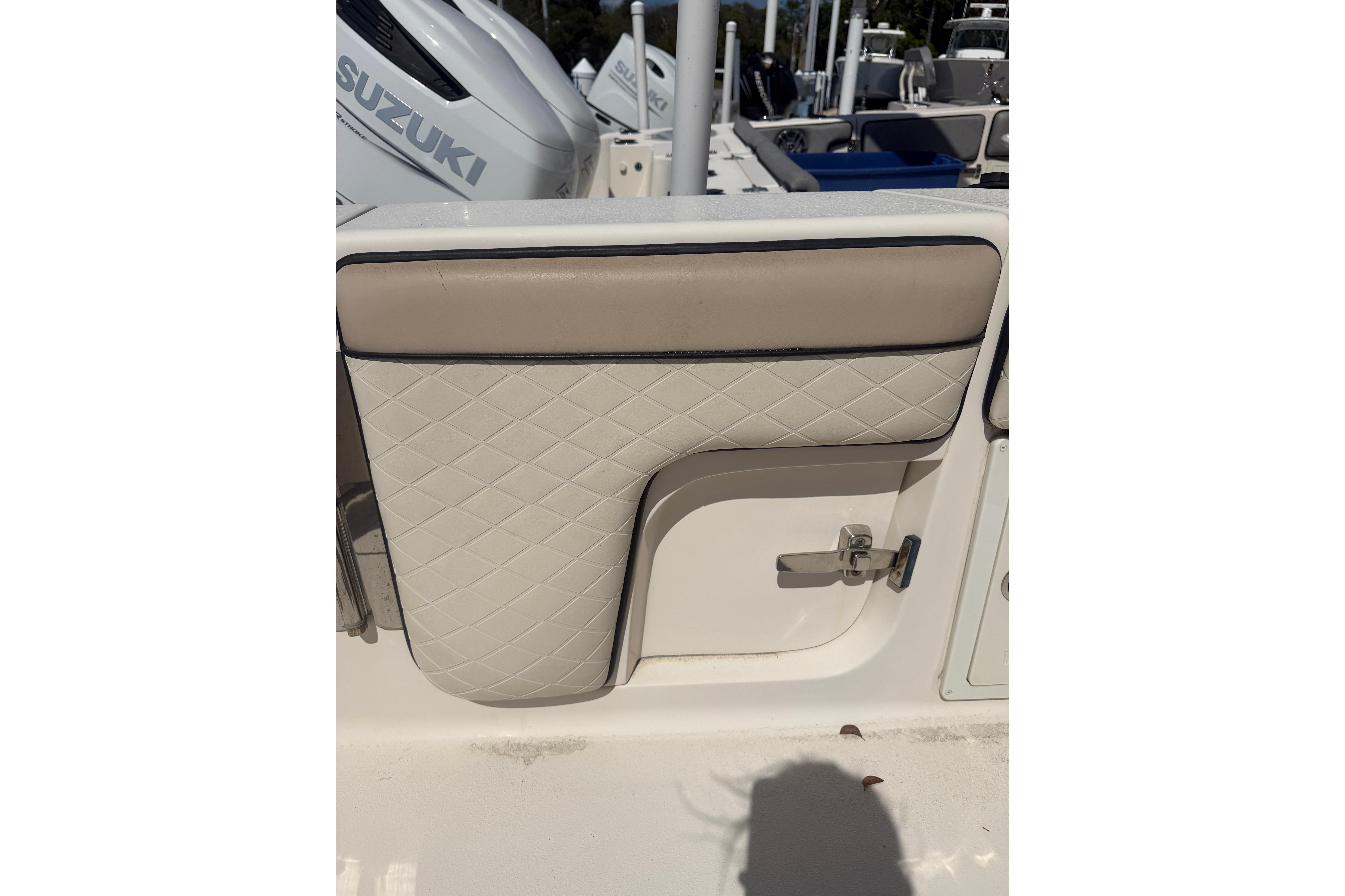 2021 Sea Chaser 30 HFC CC boat interior with quilted upholstery and Suzuki engine.