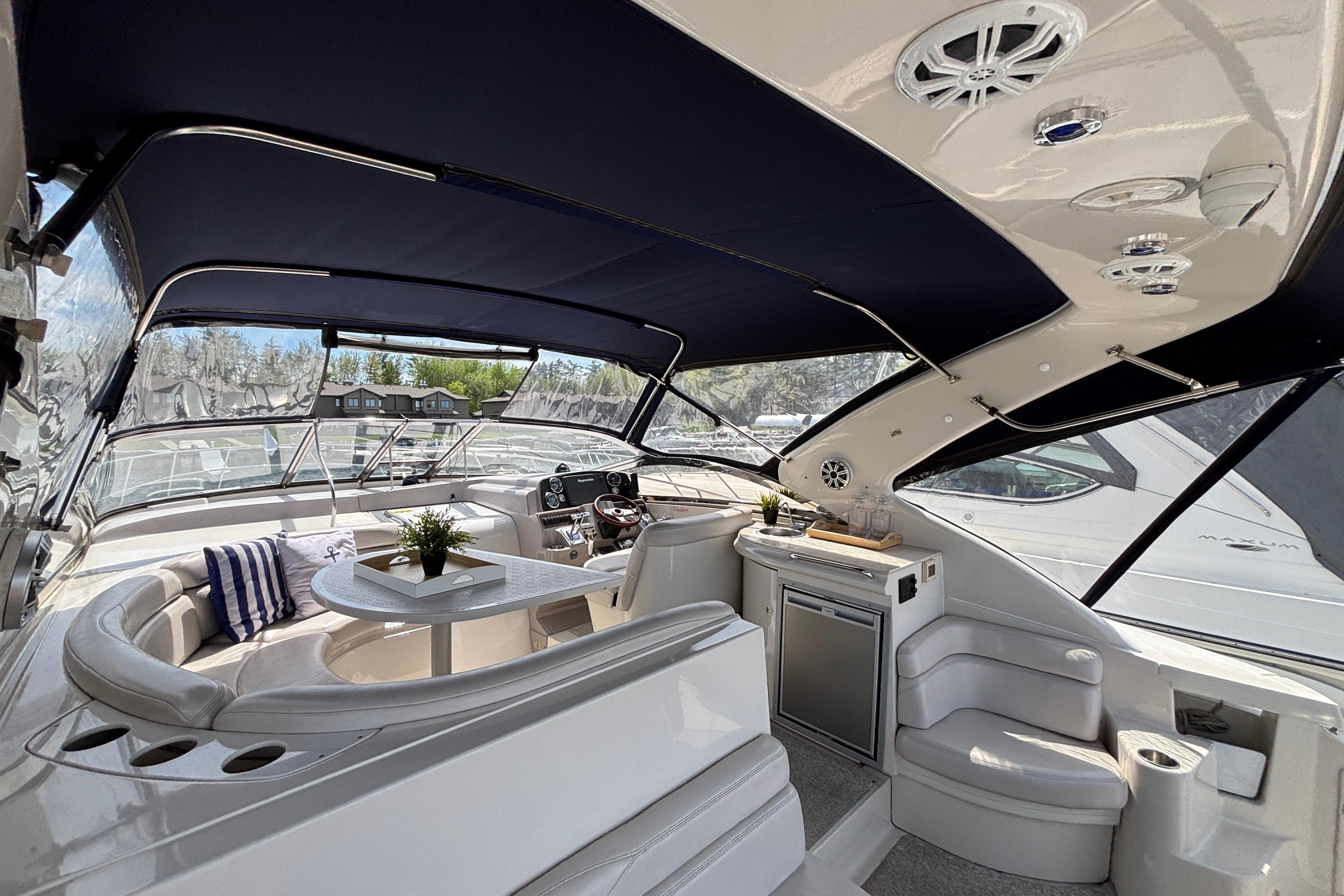 Luxurious interior of 2000 Regal Commodore 4160 yacht with seating and kitchenette.
