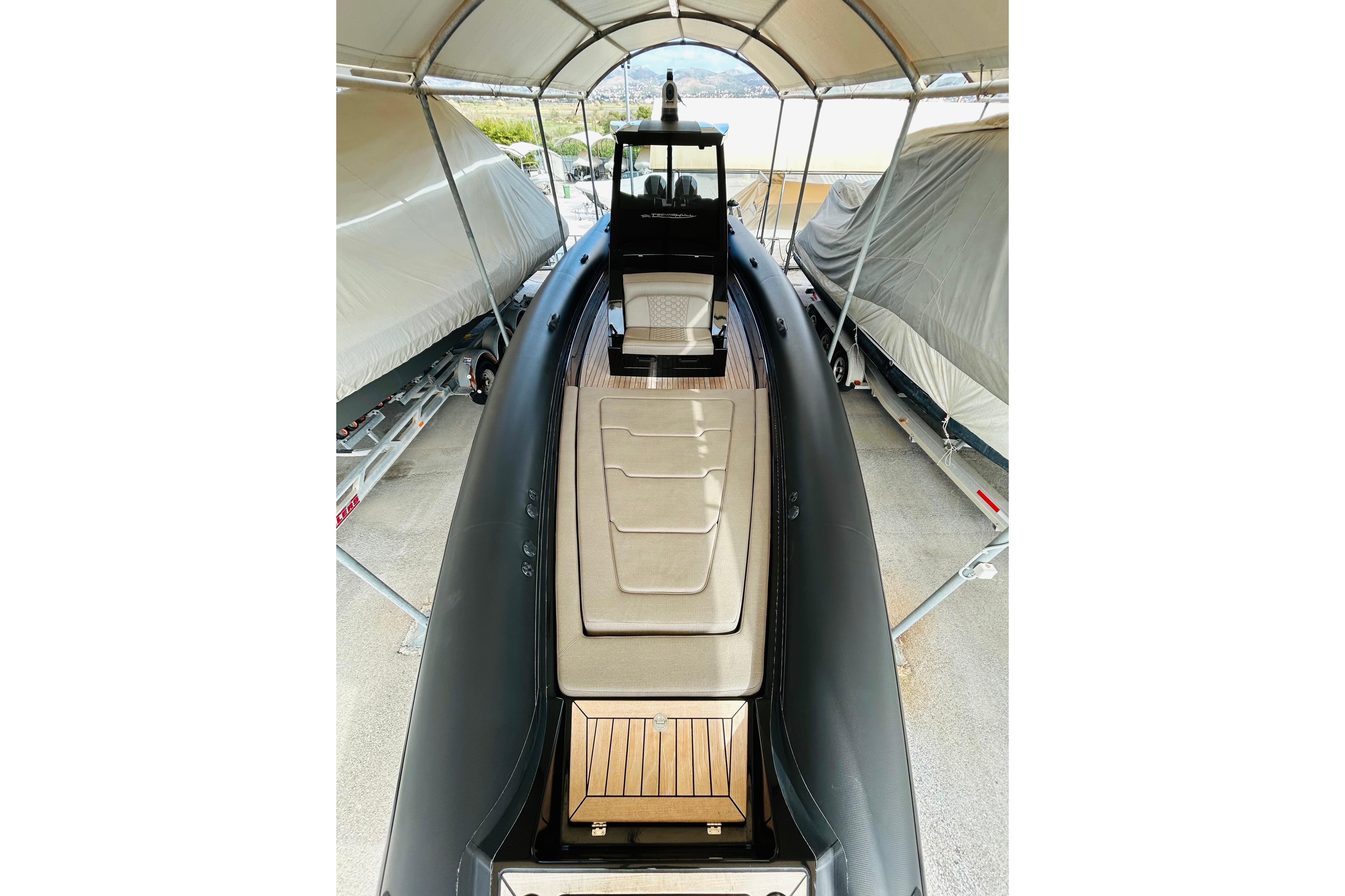 2022 Technohull 38 Grand Sport boat under a canopy, showcasing sleek design and luxury features.