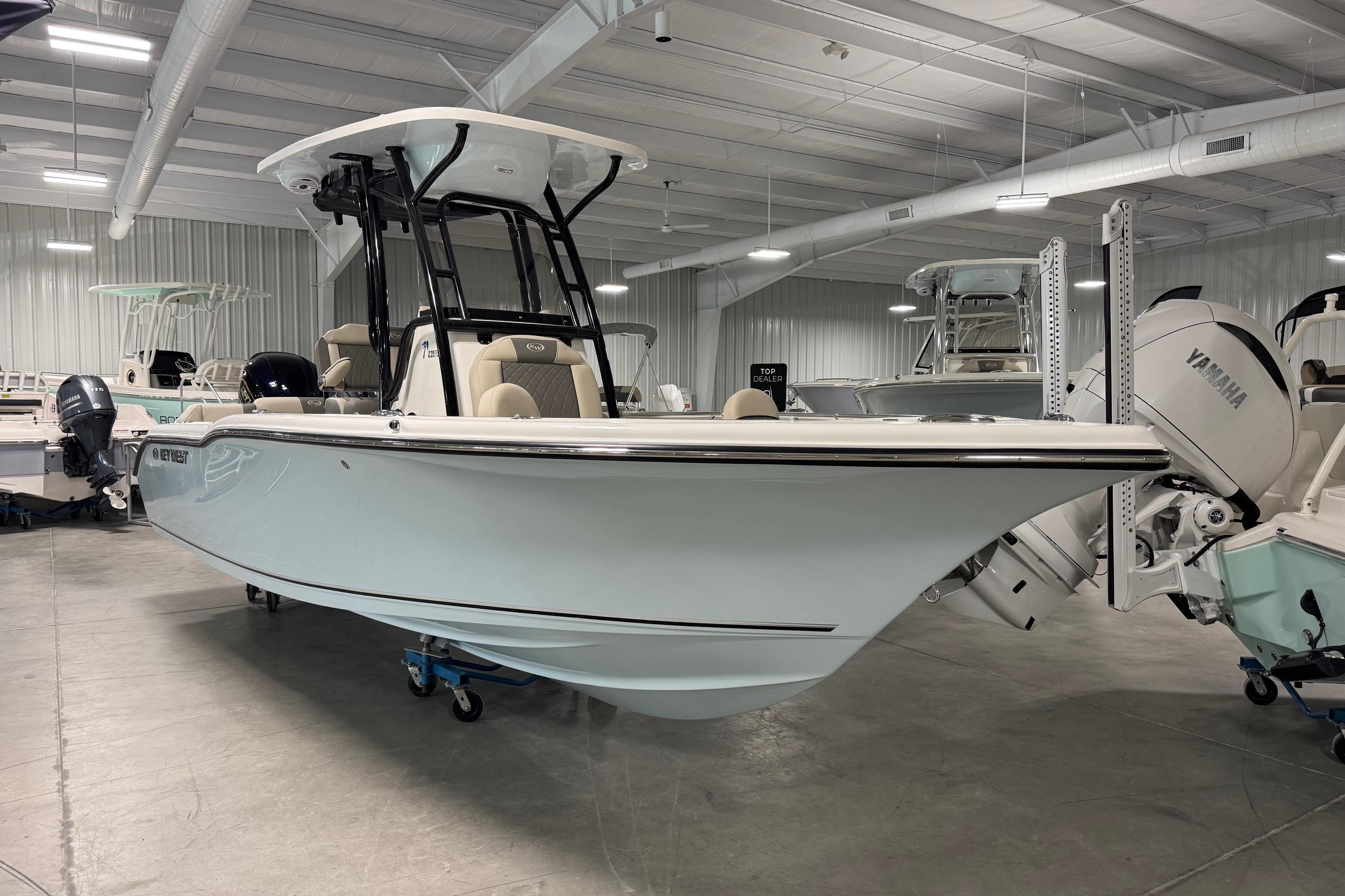 2026 Key West 239 FS boat in showroom, featuring sleek design and Yamaha outboard motor.