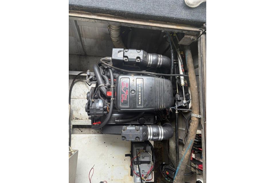 Engine compartment of a 1997 Stardust Houseboat 18x83, featuring a Volvo Penta 5.7L engine.