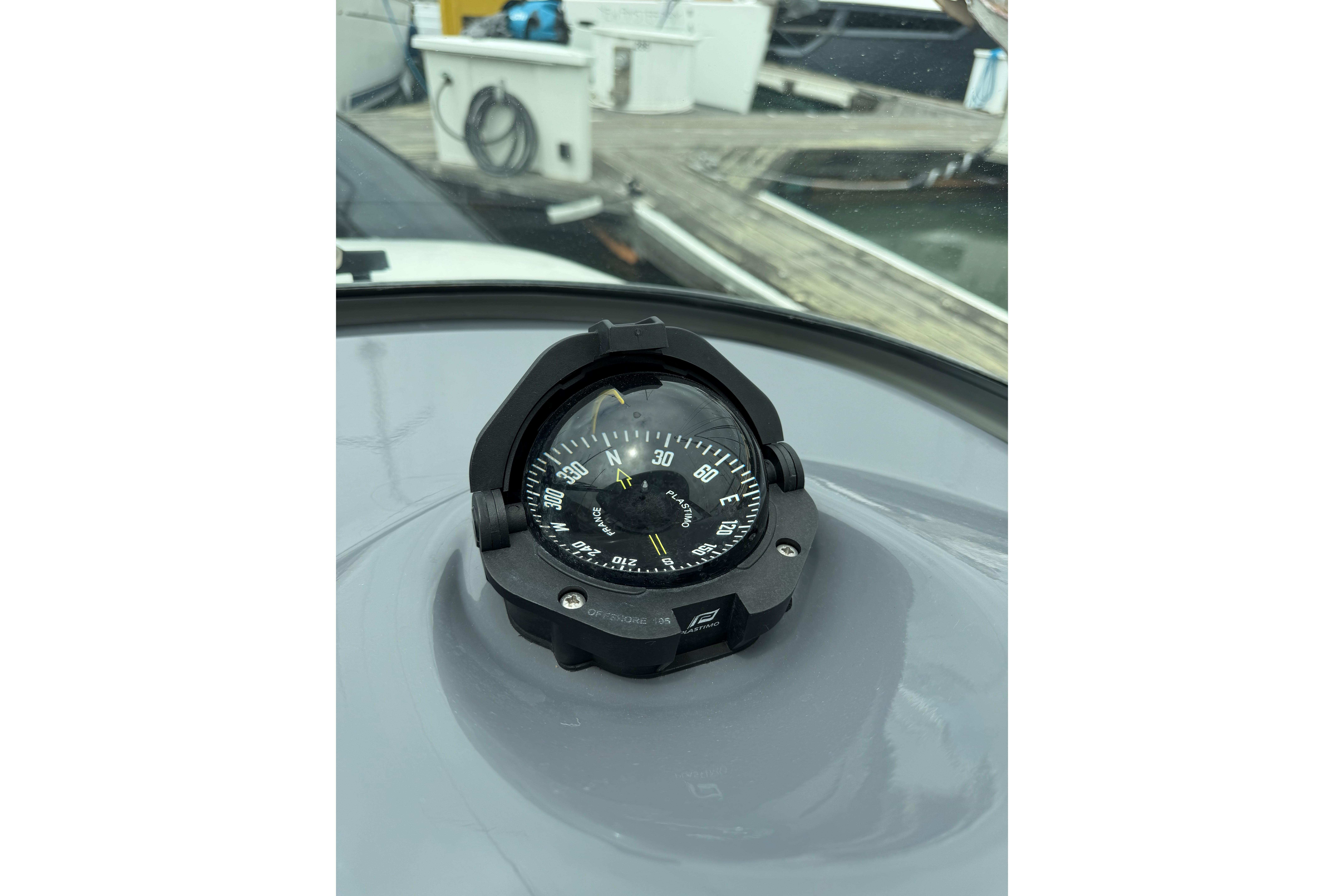Compass on 2016 Protector Targa 30 boat dashboard at marina.