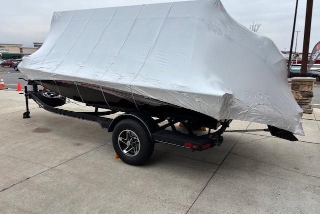 2026 Ranger RT178 boat covered on a trailer in a parking lot.