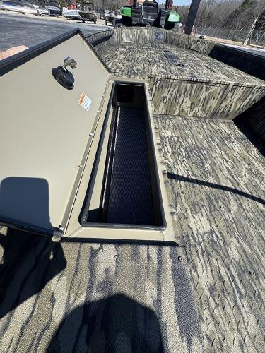 2025 SeaArk 1752 Slayer Pro boat with open storage compartment, camo design.