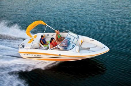 2012 Tahoe Q4 SS speedboat cruising on open water with passengers.