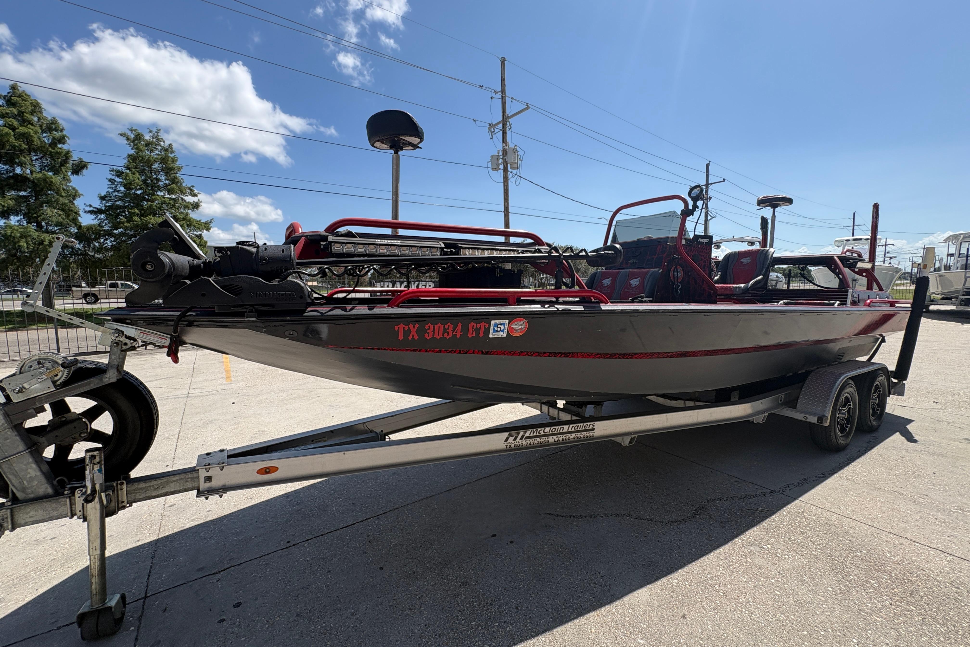 2018 Custom Swamp Shark 24' boat on trailer under clear blue sky.