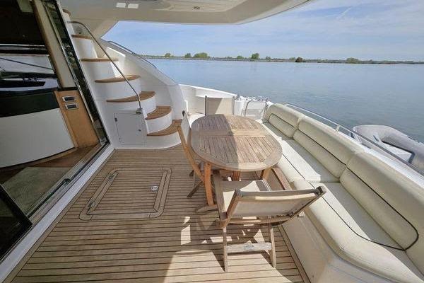 Luxury Sunseeker Manhattan 66 yacht deck with seating and table, 2005 model.
