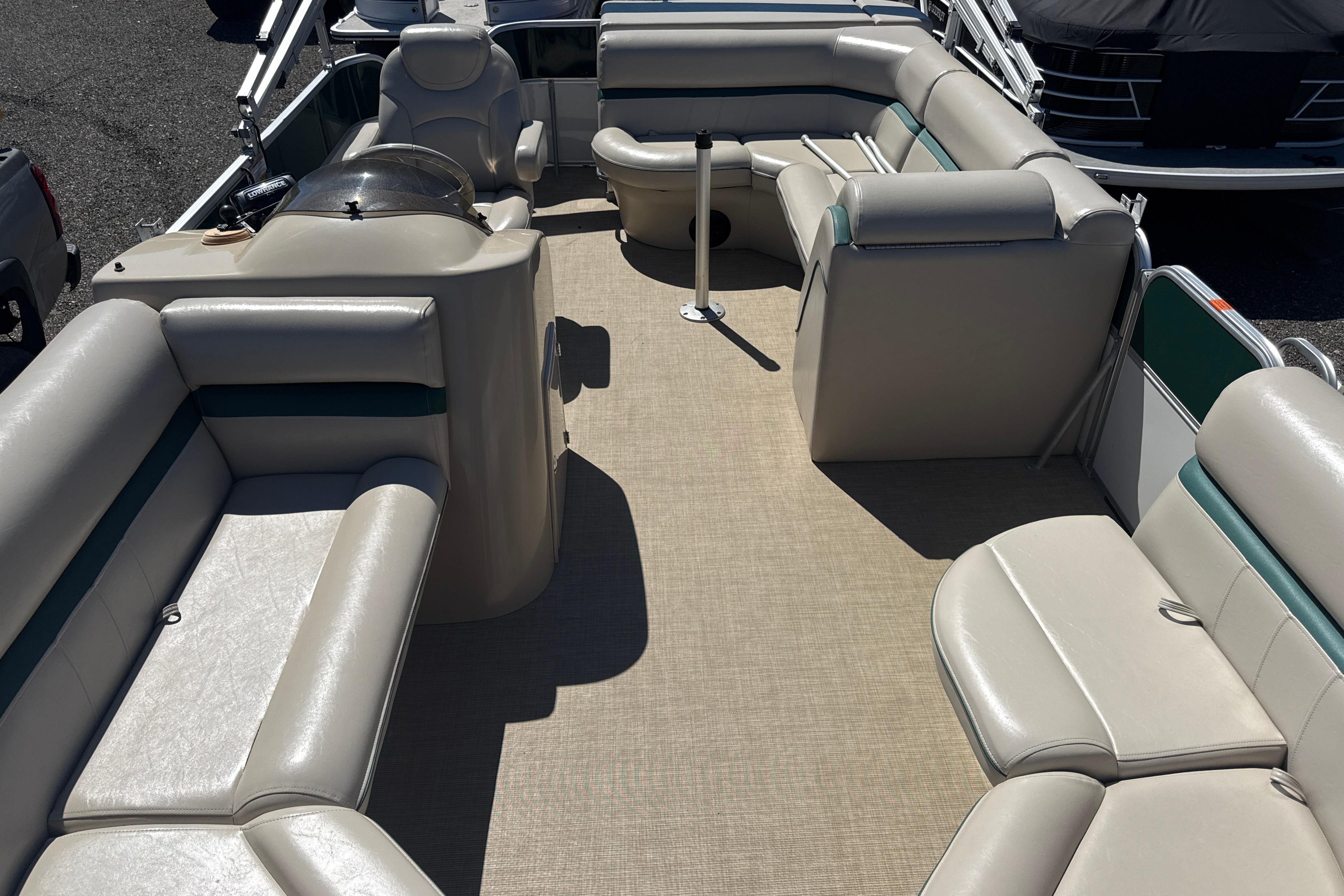 Interior of a 2016 Berkshire 20 pontoon boat with beige seating and helm.