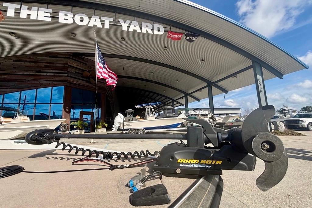 Outdoor boat dealership with Minn Kota motor and 2008 Ranger 180 Reata boat displayed.