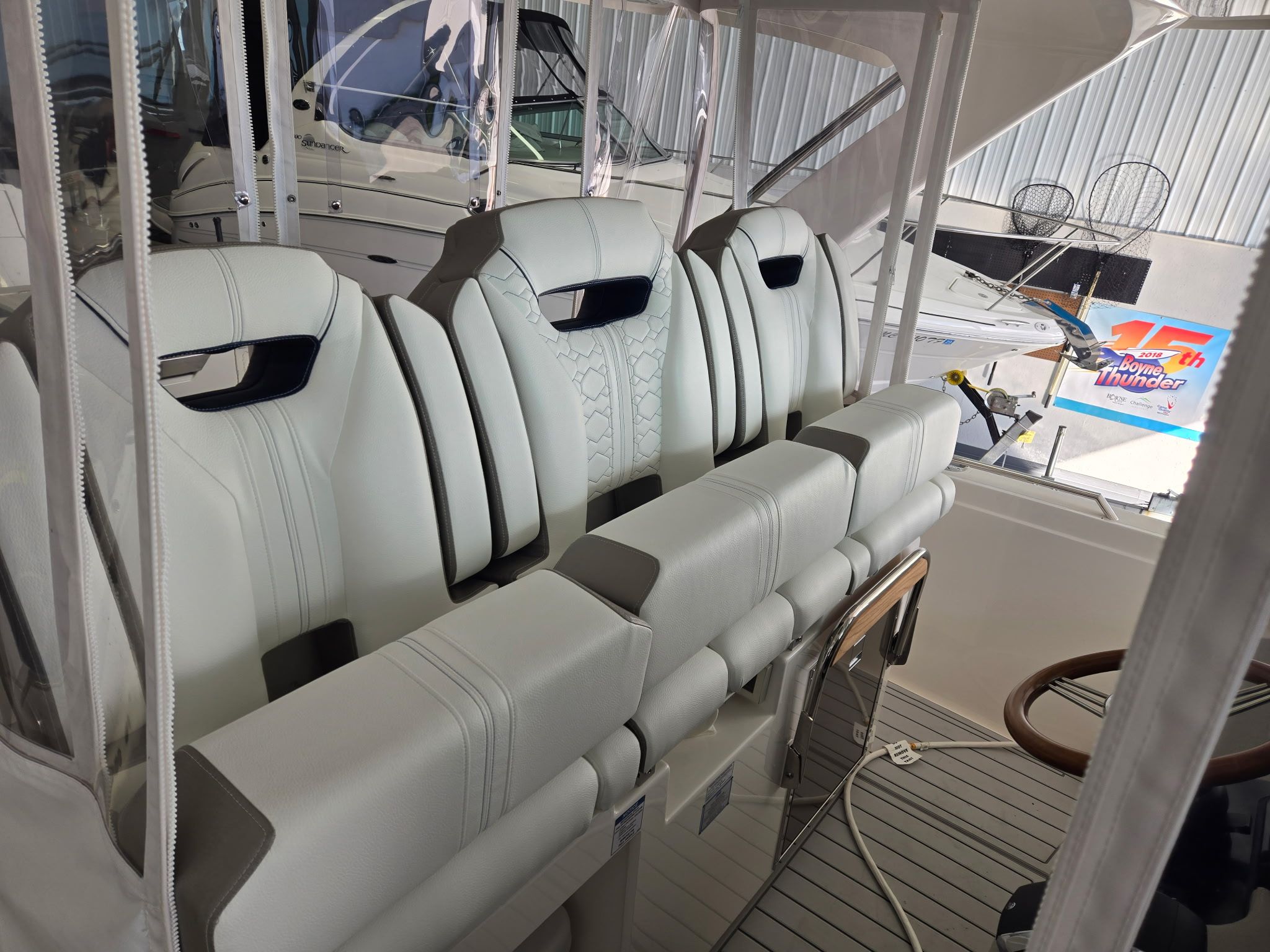 The 2010 Sea Ray Sundancer 310 features white leather seats in the cockpit.