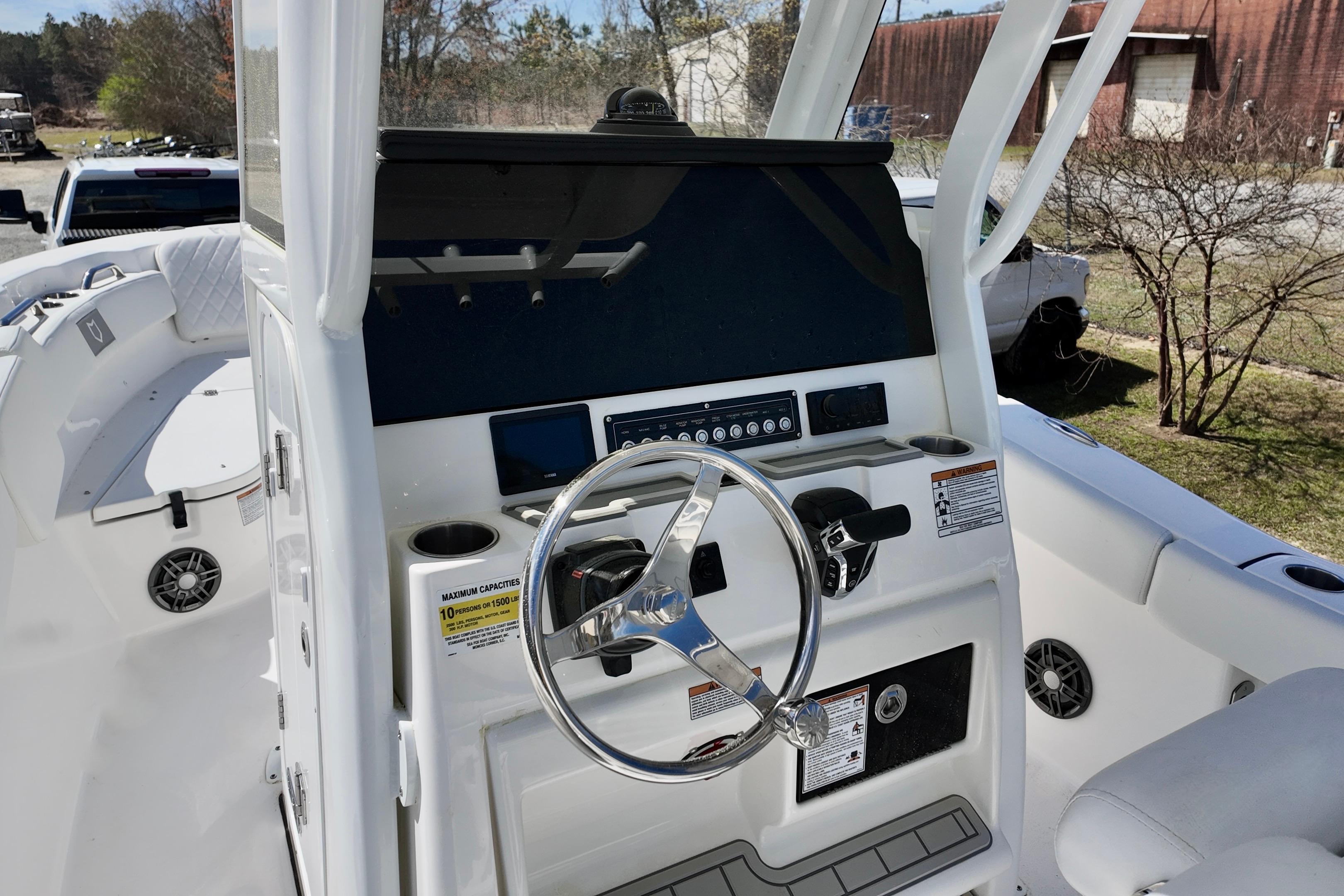 2026 Sea Fox 248 Commander boat console with steering wheel and control panel.