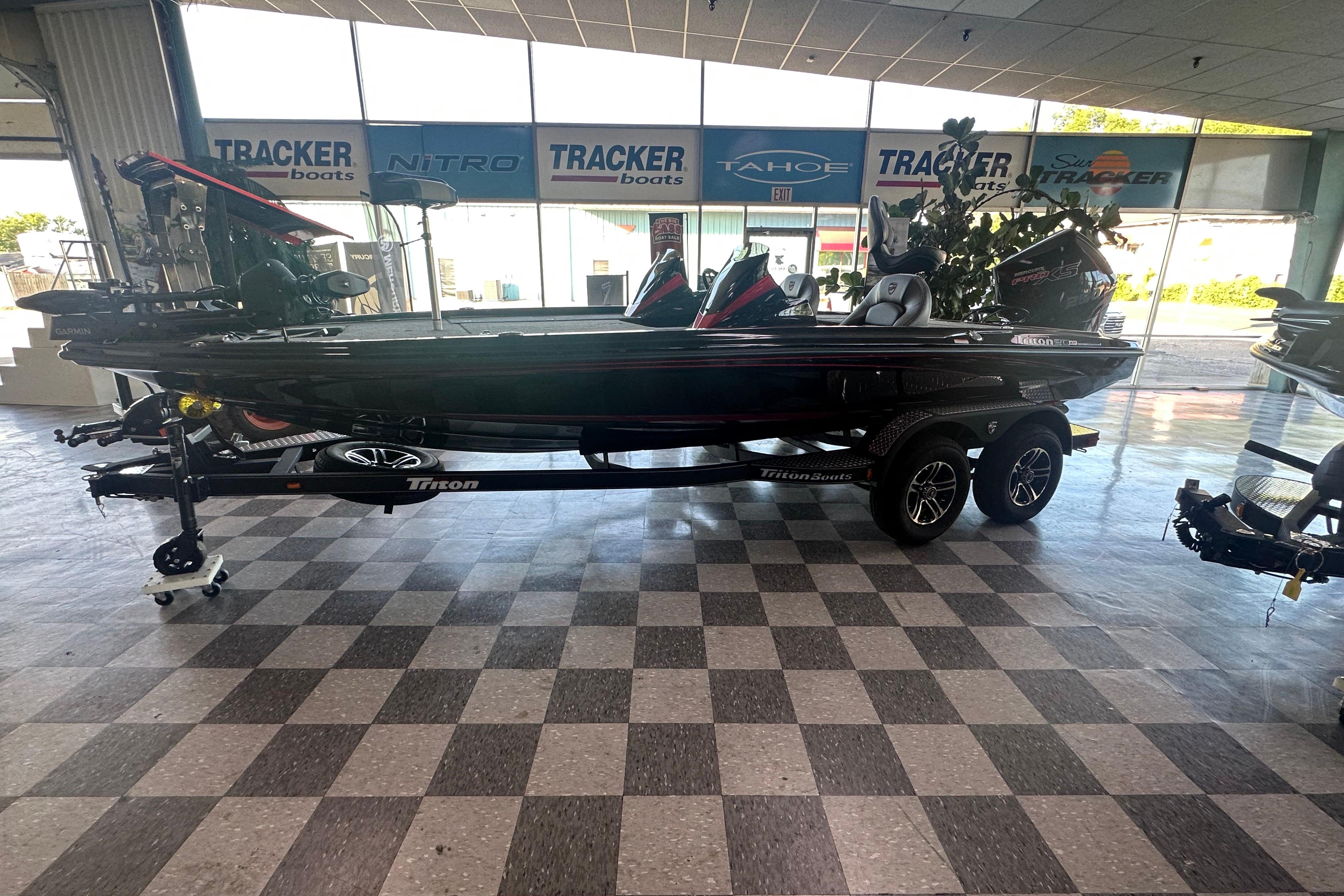 2026 Triton 20XP Patriot boat displayed in showroom with checkered floor.