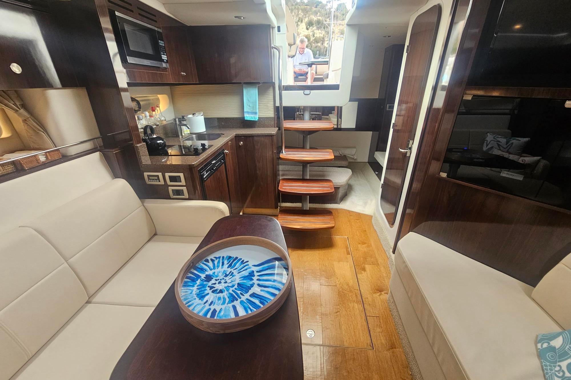 Interior of 2016 Sea Ray Sundancer 350 yacht with modern kitchen and seating area.