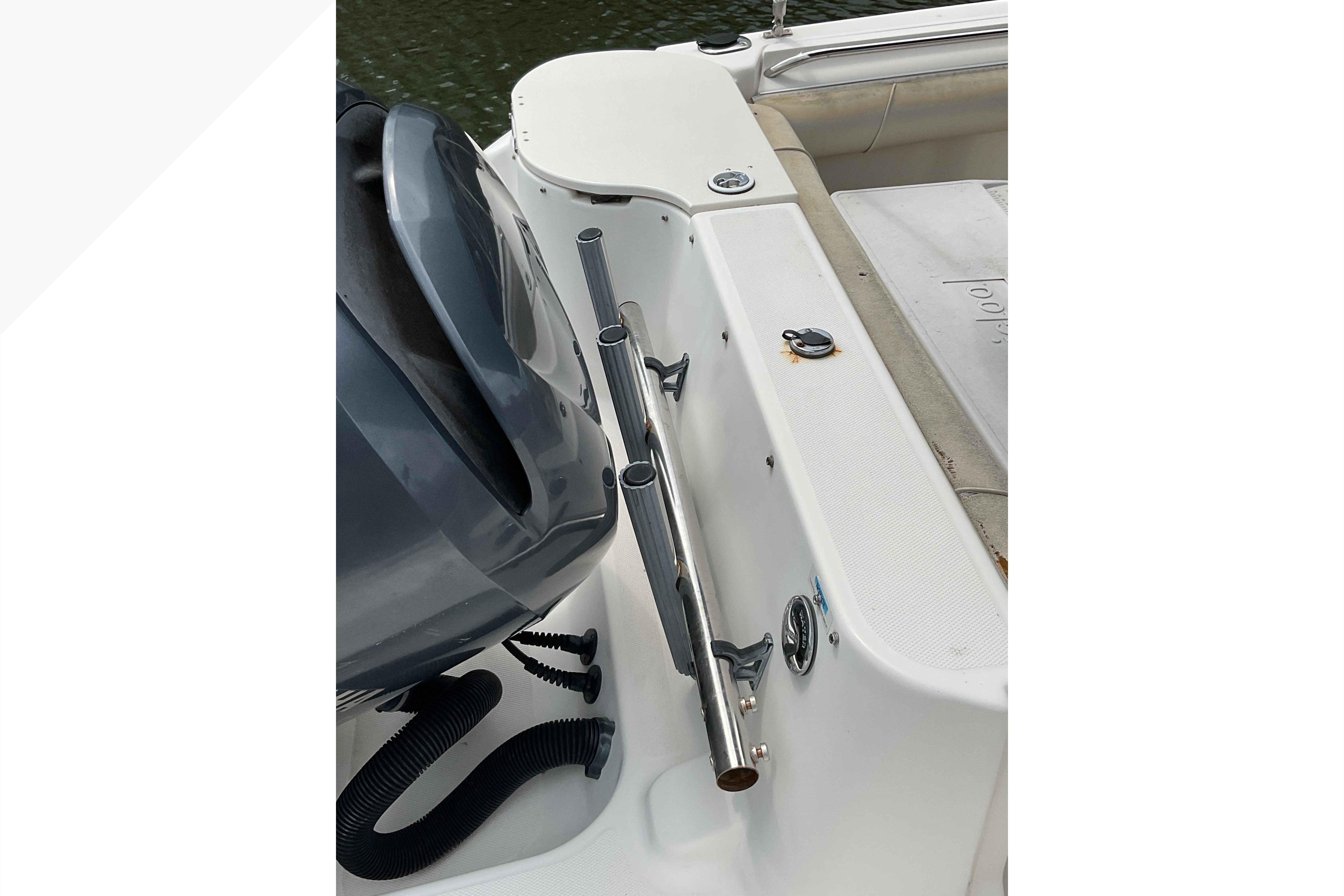 2012 Wellcraft 232 Coastal boat interior with motor and rod holder.