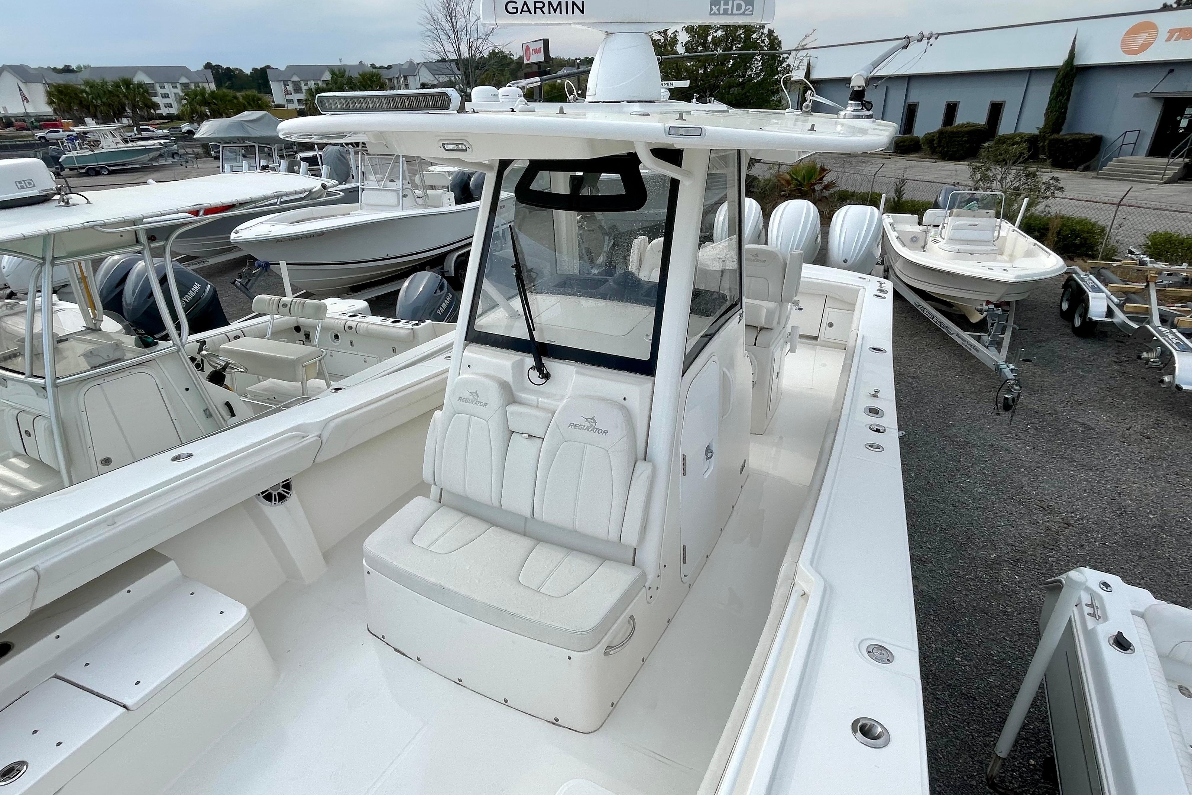 2023 Regulator 34 boat with center console and seating, displayed in a marina setting.