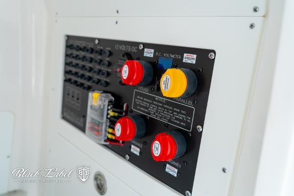 Control panel of 2025 Caymas 281 HB boat with labeled switches and dials.