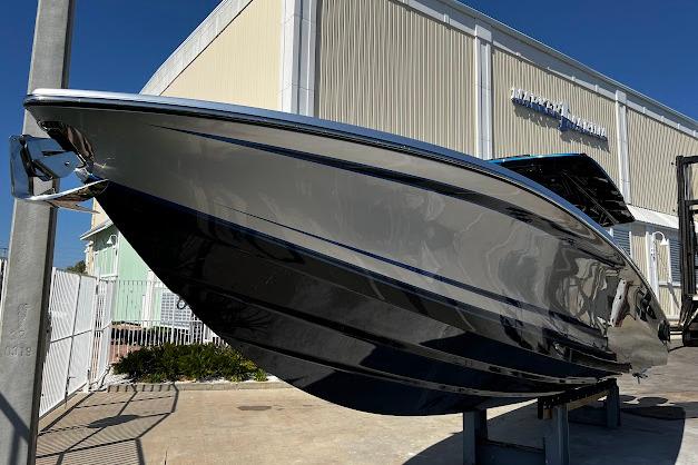 2022 Nor-Tech 390 Sport Center Console boat displayed outdoors near a building.
