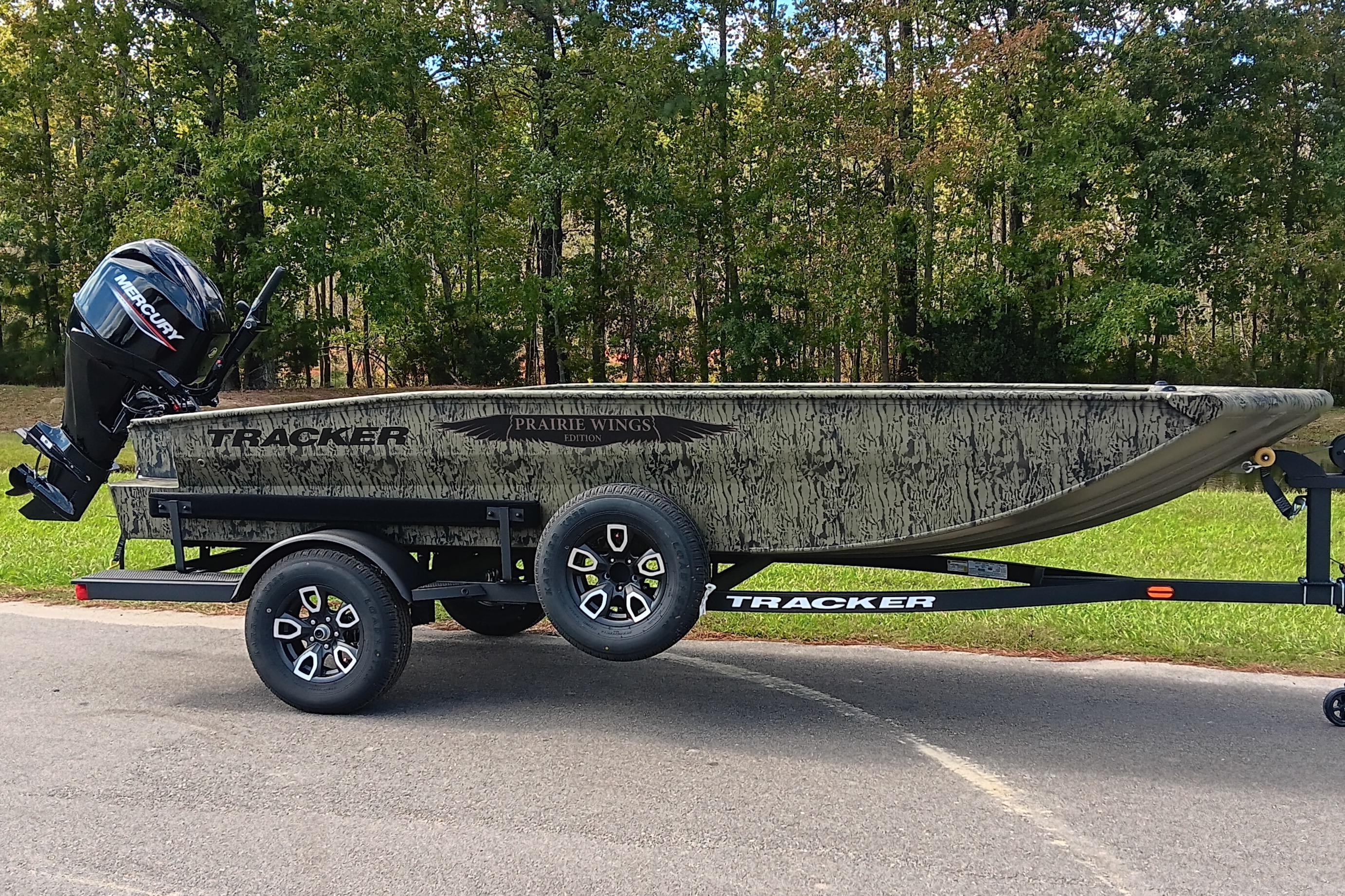2026 Tracker Grizzly 1650 T Prairie Wings Edition boat on trailer, outdoors.