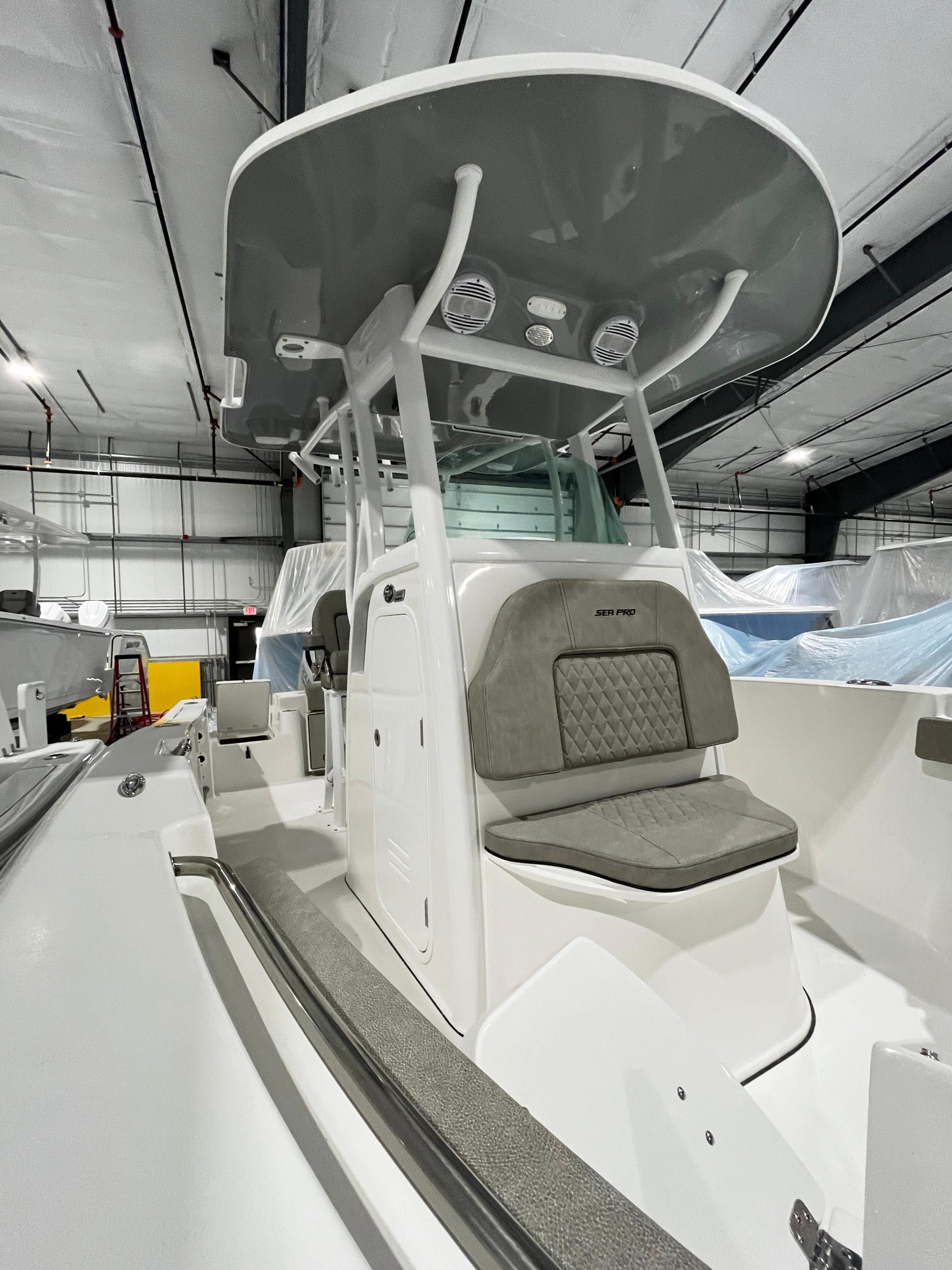 2024 Sea Pro 242 DLX center console boat in a storage facility.