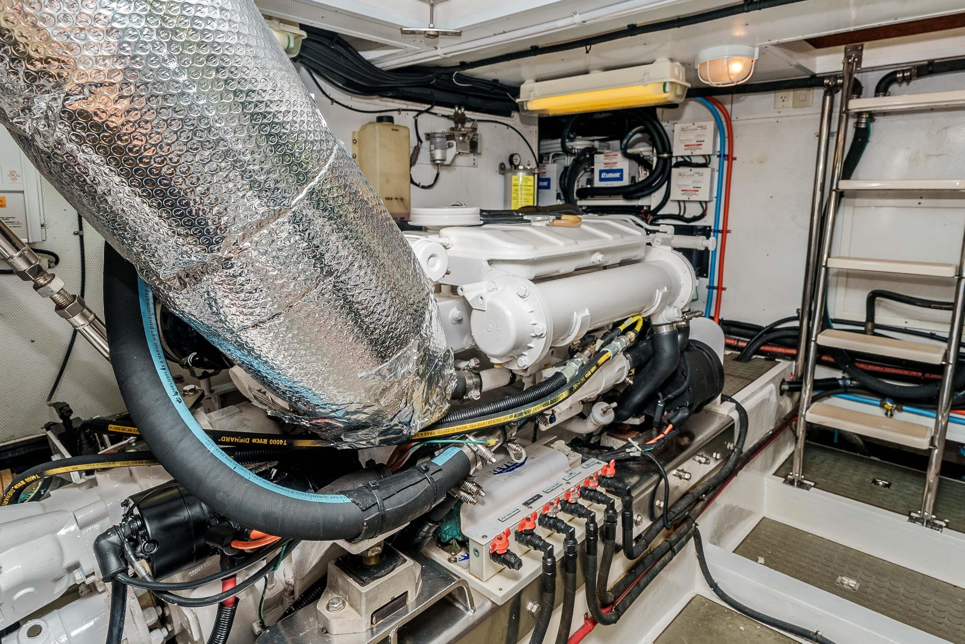 Engine room of 2005 Offshore Yachts 54 Pilothouse, showcasing machinery and wiring.