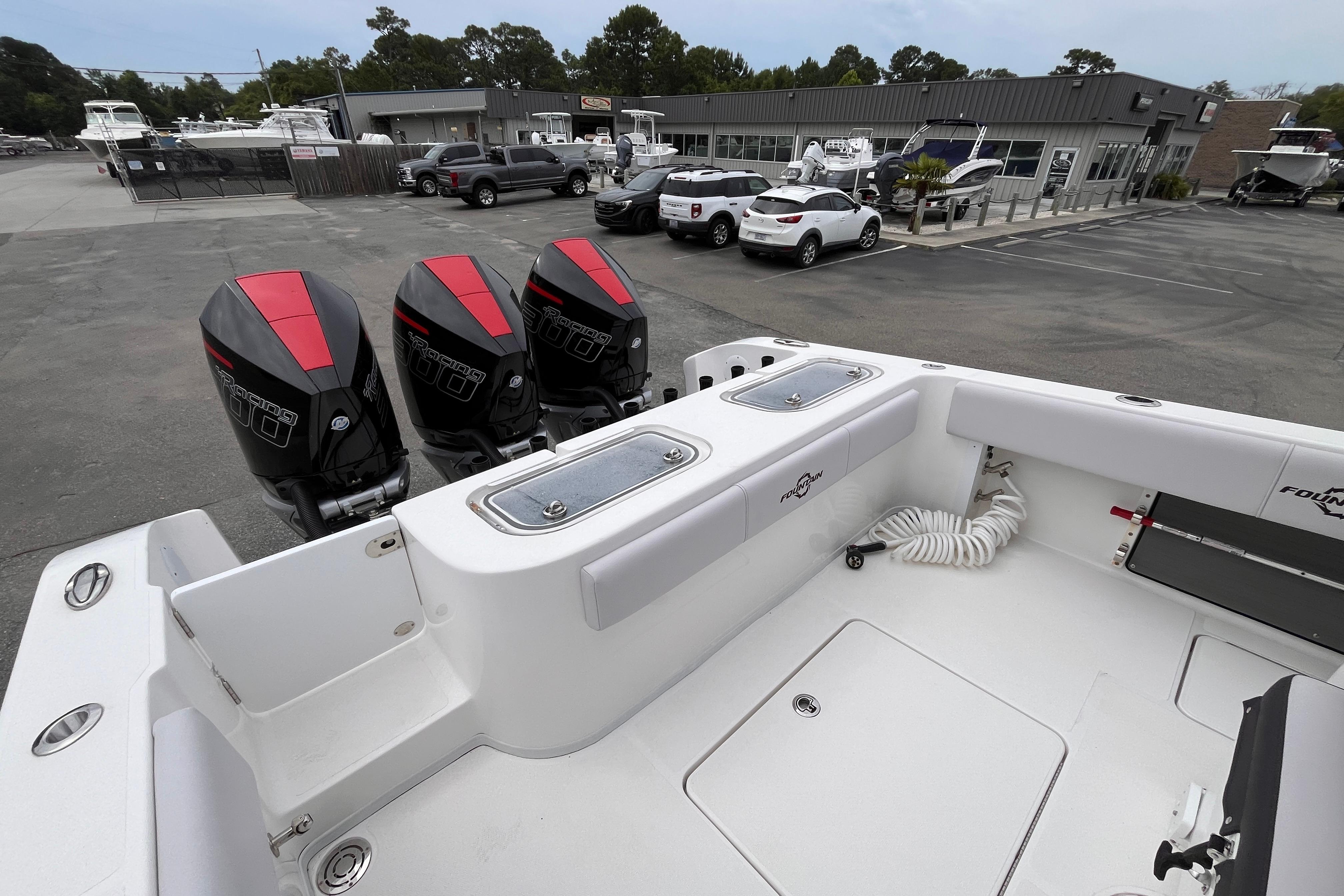 2024 Fountain 34 Tournament Edition boat with triple outboard motors in a marina setting.