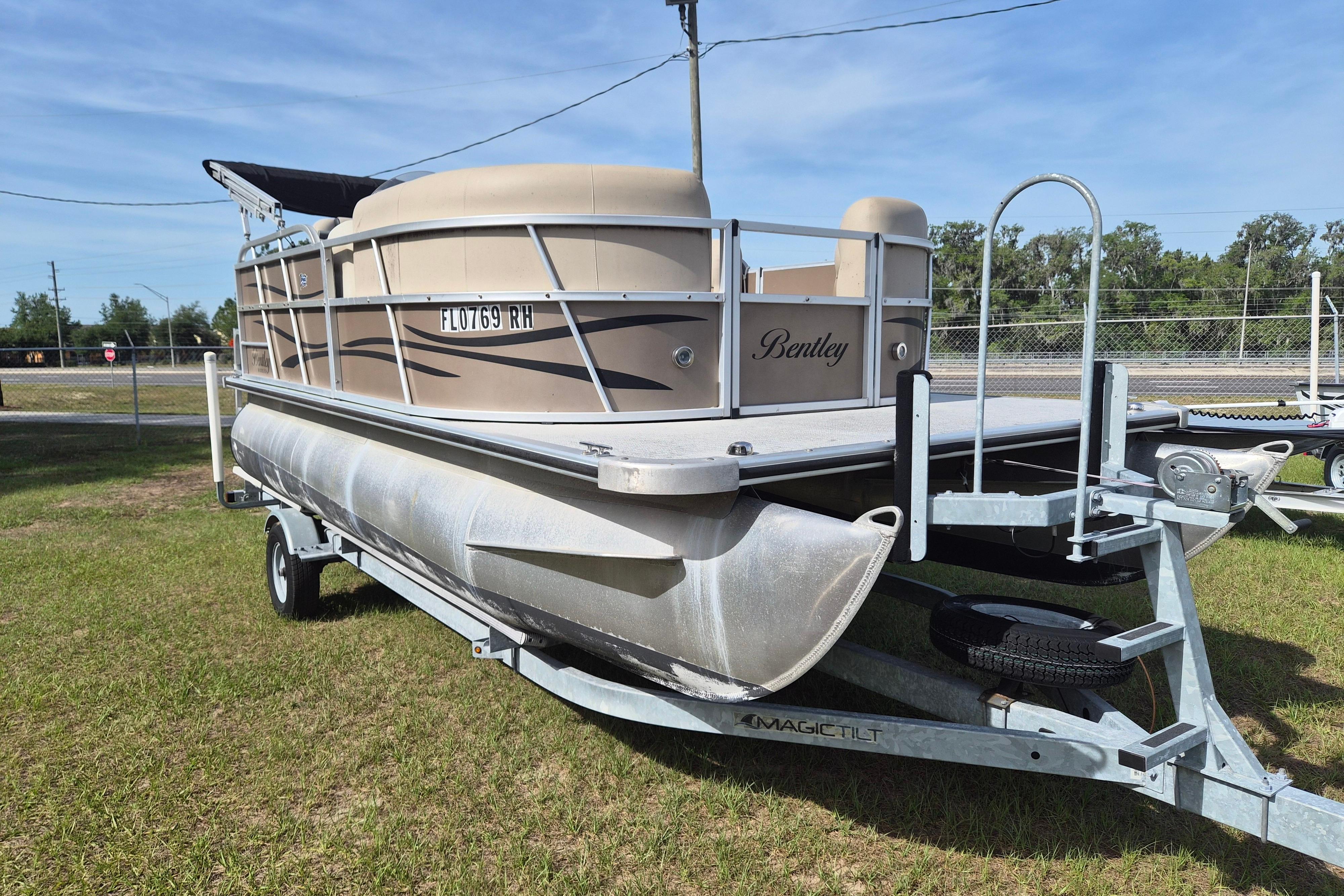 2004 Bentley Pontoons 180 CRUISE on trailer, parked on grass under clear sky.