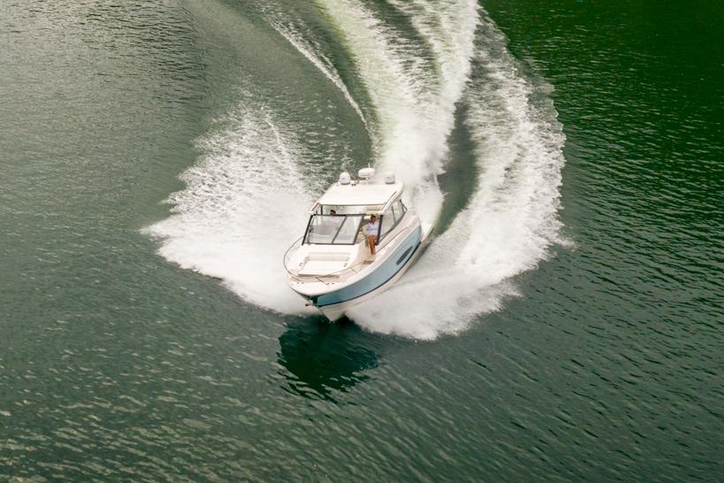 Manufacturer Provided Image: 2026 Regal 36 Grande Coupe cruising on open water, creating dynamic waves.