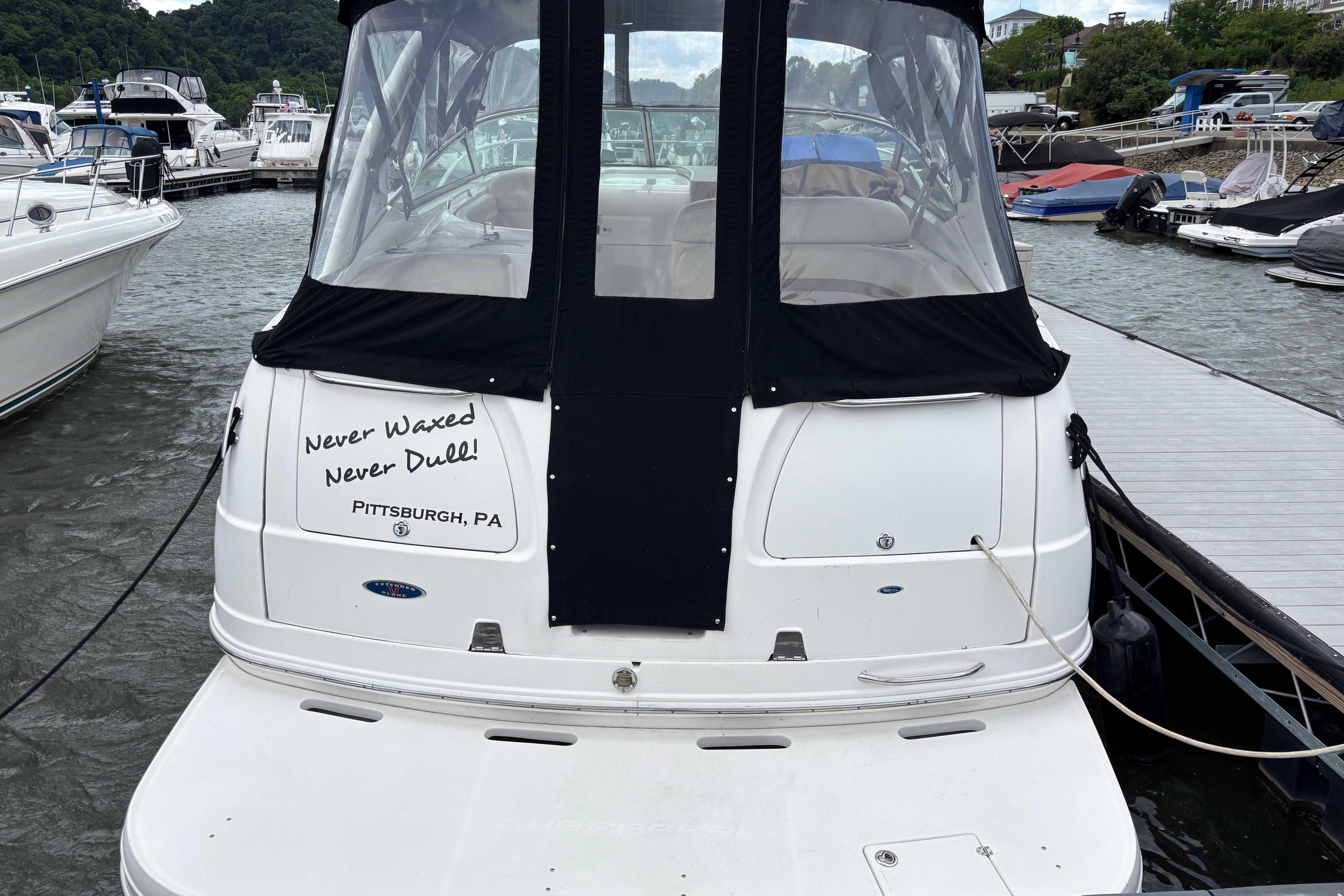2004 Chaparral Signature 330 docked in Pittsburgh marina, featuring custom text on the stern.