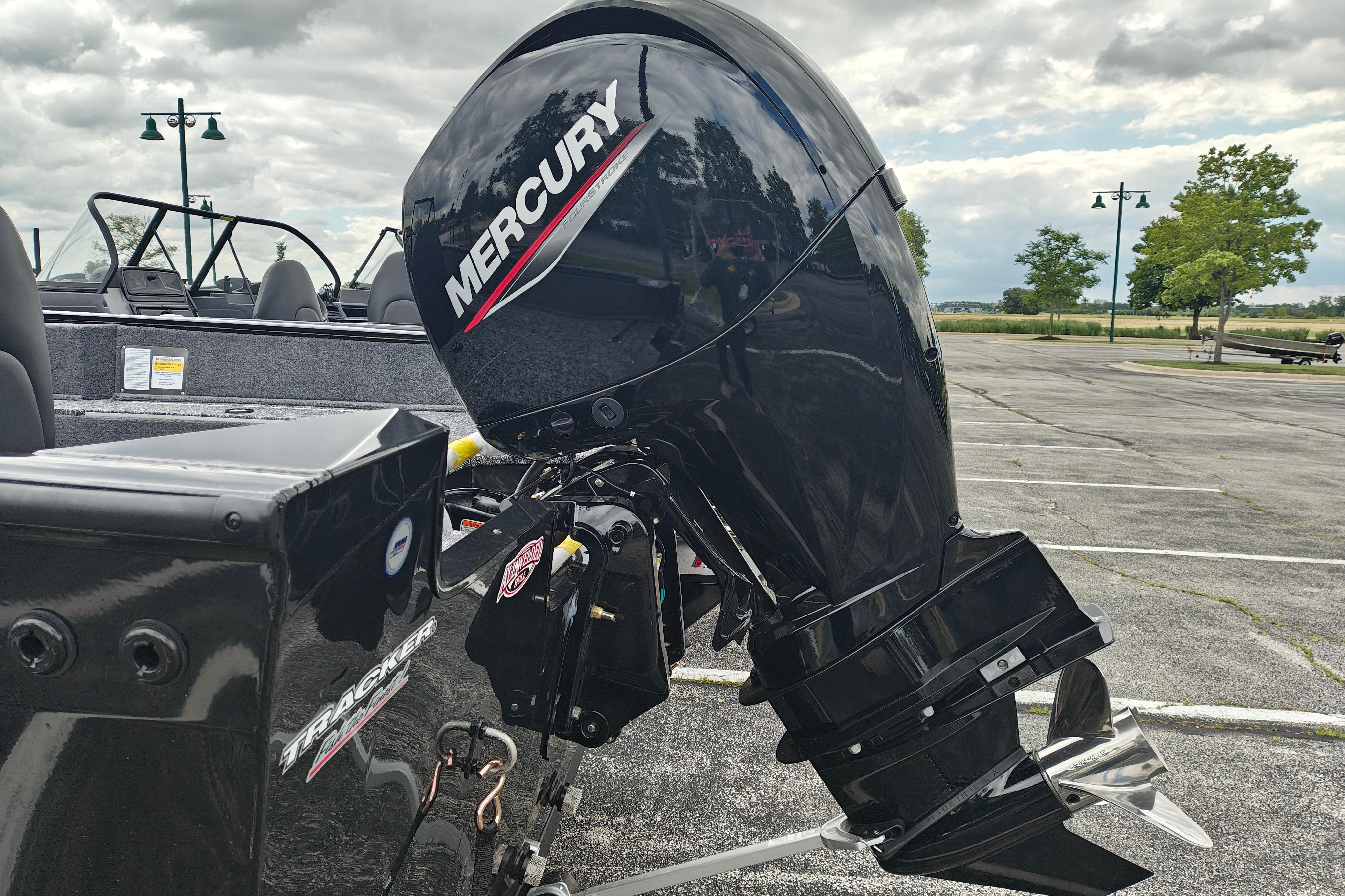 2026 Tracker Pro Guide V-175 WT boat with Mercury outboard motor in a parking lot.