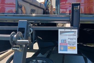 2026 Regency 250 DL boat trailer with price tag and winch mechanism.