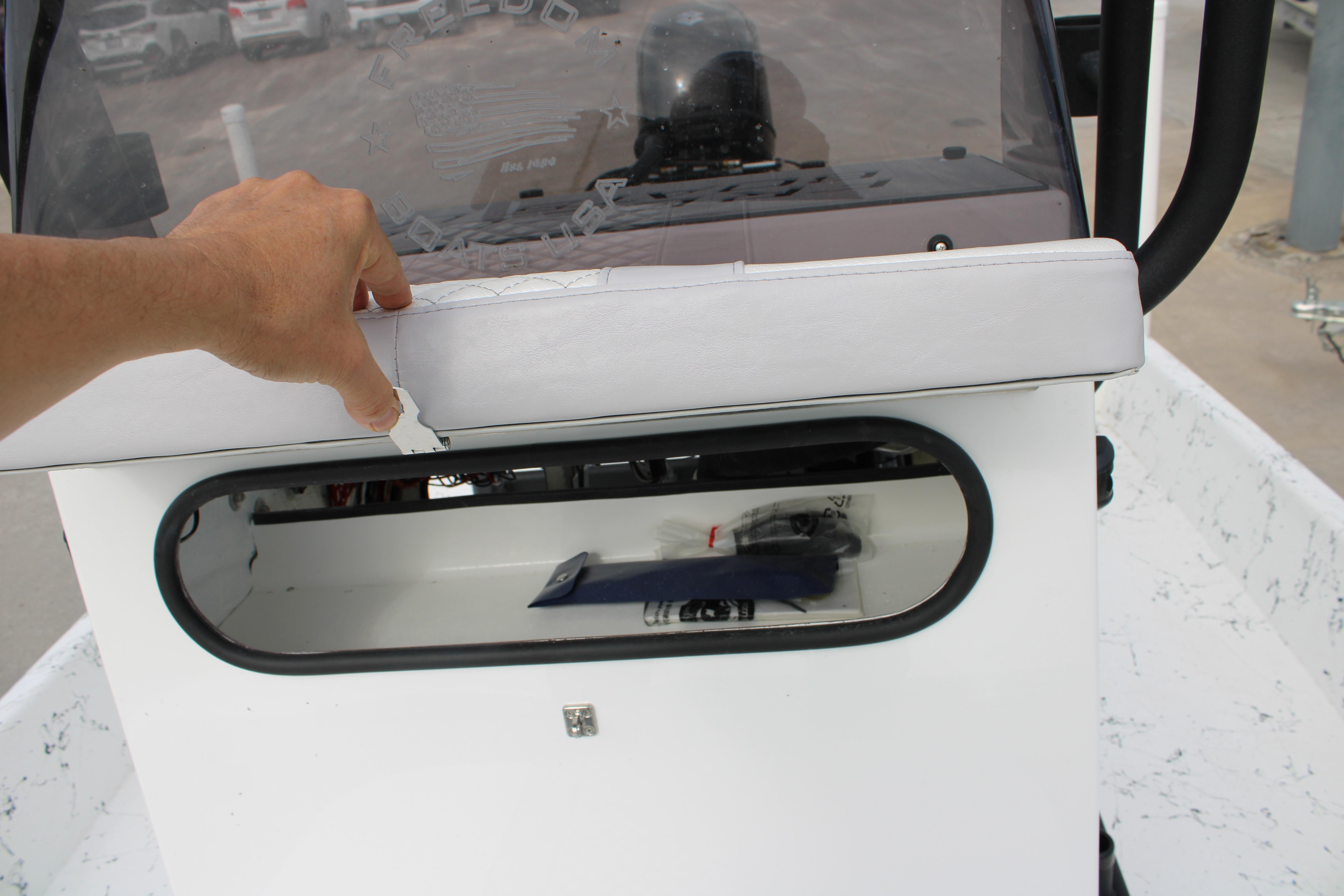Hand opening storage compartment on 2026 Freedom Boats 19 PATRIOT console.