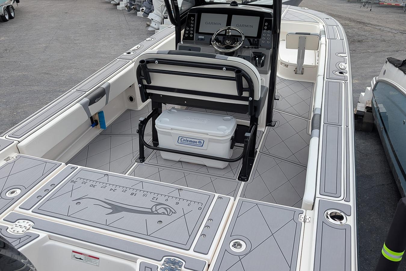 2023 Robalo 266 Cayman boat interior with Garmin displays and Coleman cooler.