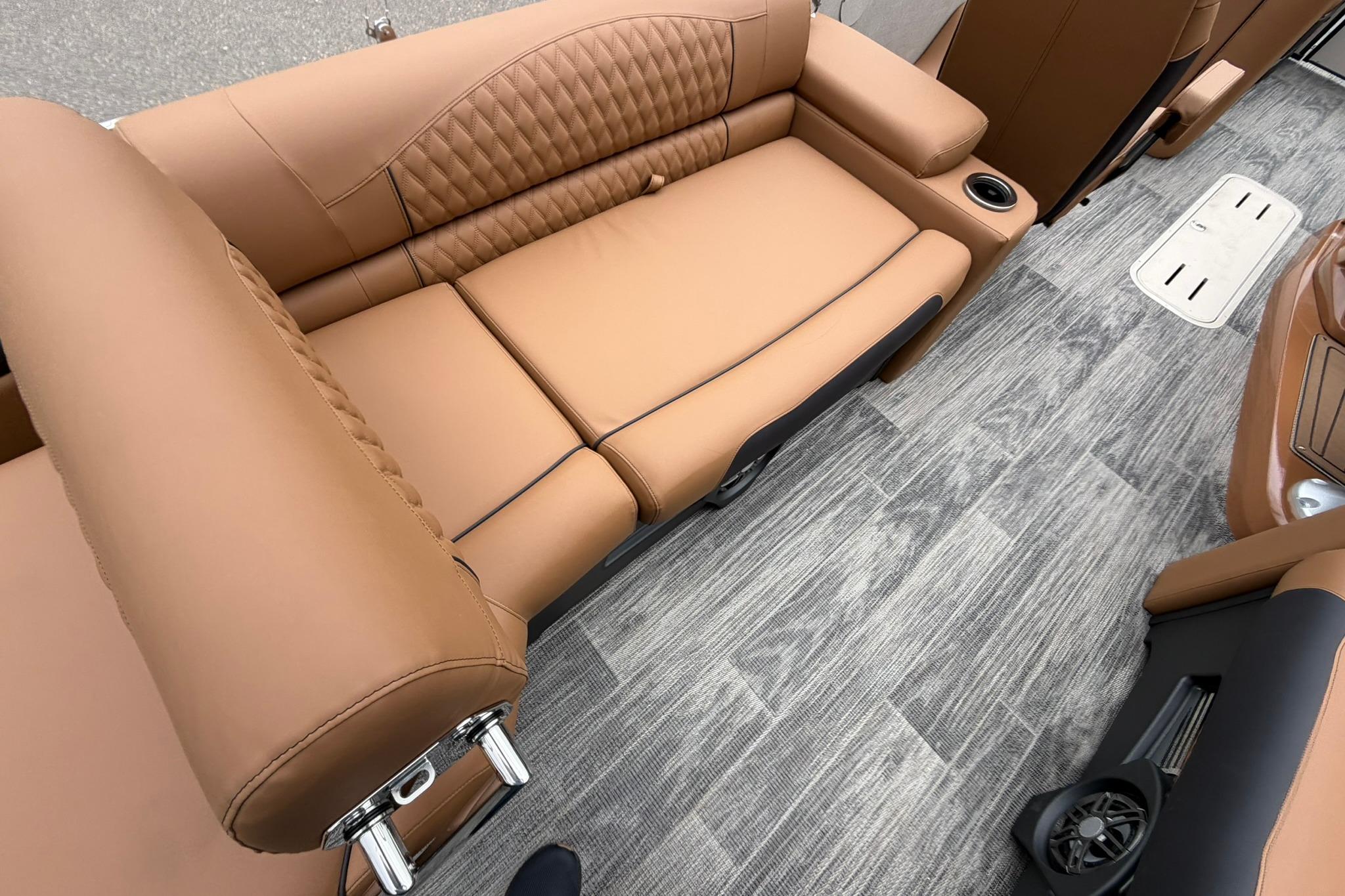 Luxurious tan seating on 2026 Avalon Catalina Quad Lounge boat interior.