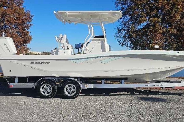 2026 Ranger 2660 Bay boat on trailer, parked outdoors under clear blue sky.