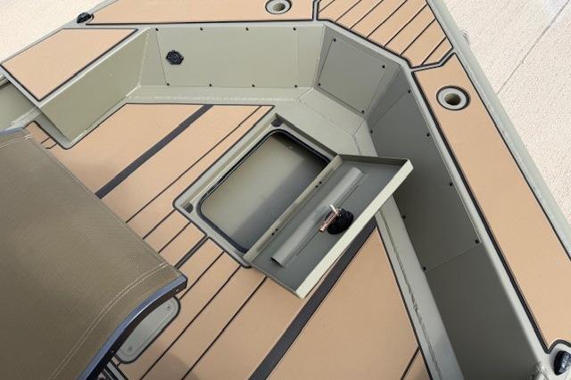 2026 Tracker Grizzly 1756 T Marsh boat interior with storage compartment and seating.