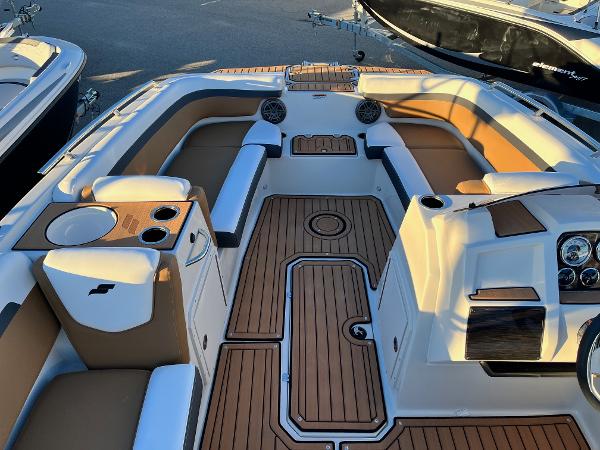 2024 Starcraft SVX 191 boat interior with tan and white seating, wood accents, and cup holders.