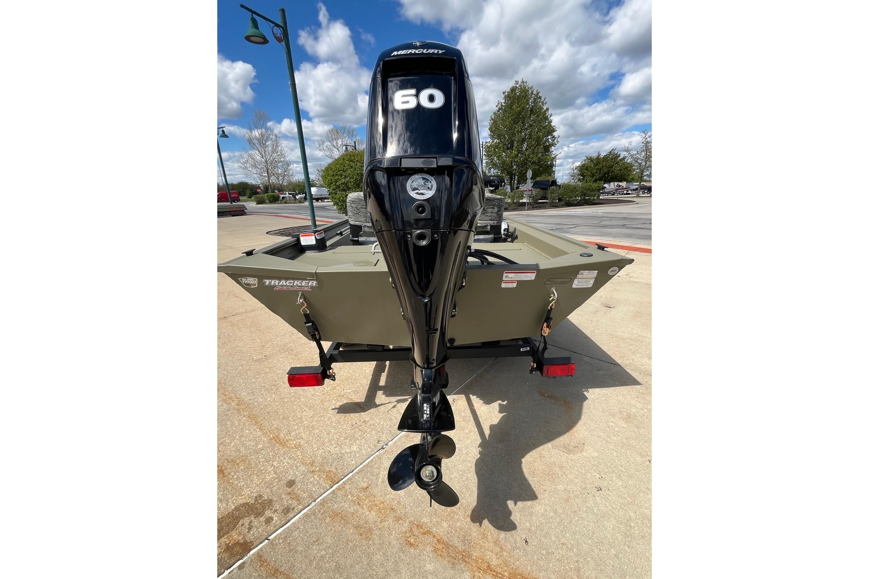 2026 Tracker Grizzly 1754 SC boat with Mercury 60 outboard motor, parked outdoors.