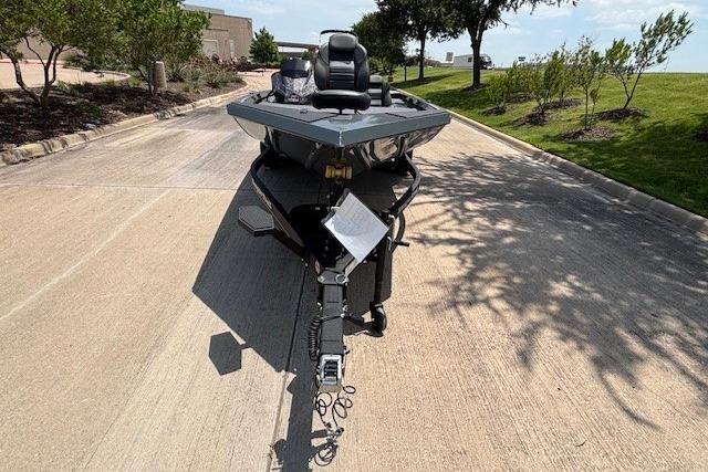 2026 Ranger RT188 boat on trailer, parked on a sunny road with trees nearby.