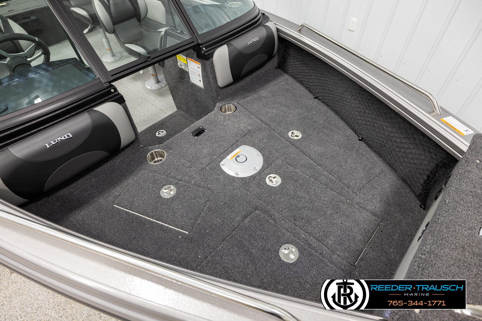 Interior of 2026 Lund 1975 Tyee boat with carpeted flooring and seating.