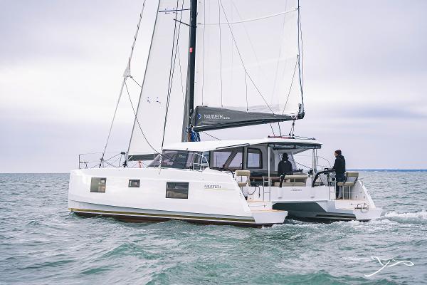 2025 Nautitech 40 Open catamaran sailing on the ocean with two people onboard.