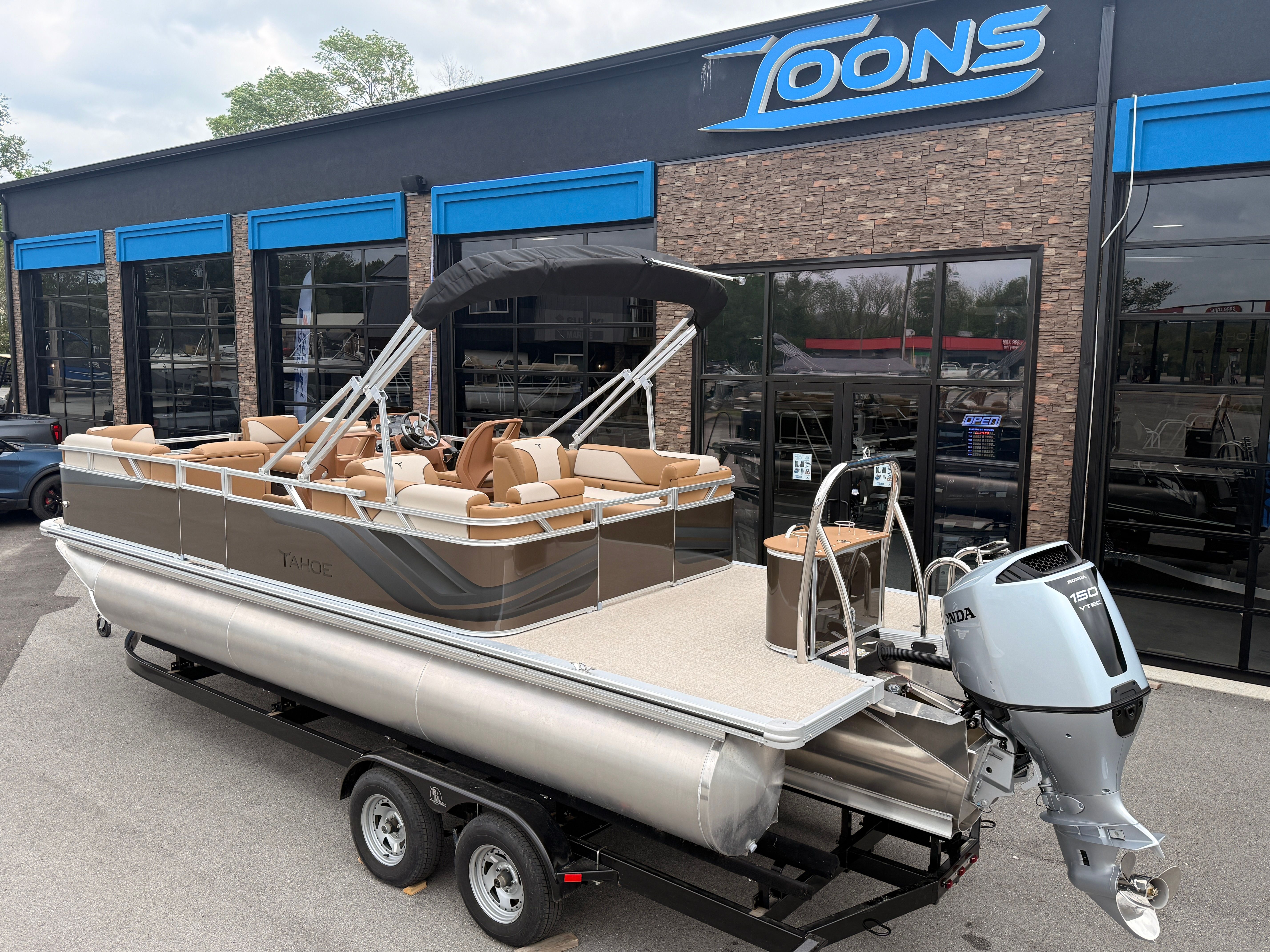 2026 Tahoe 2380 Sport Quad Lounger pontoon boat outside a dealership.