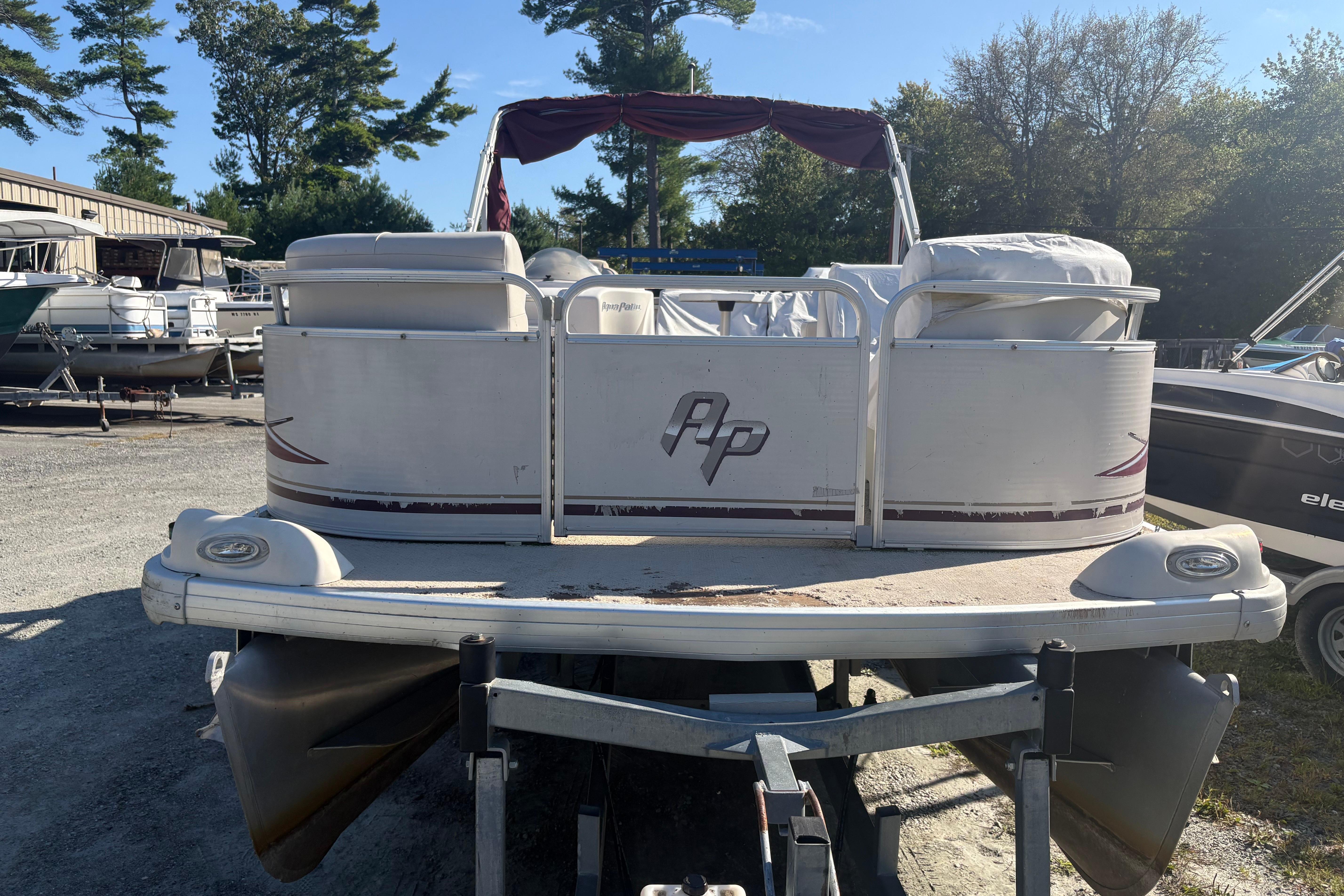 2003 Aqua Patio 200RE pontoon boat on trailer in outdoor storage area.