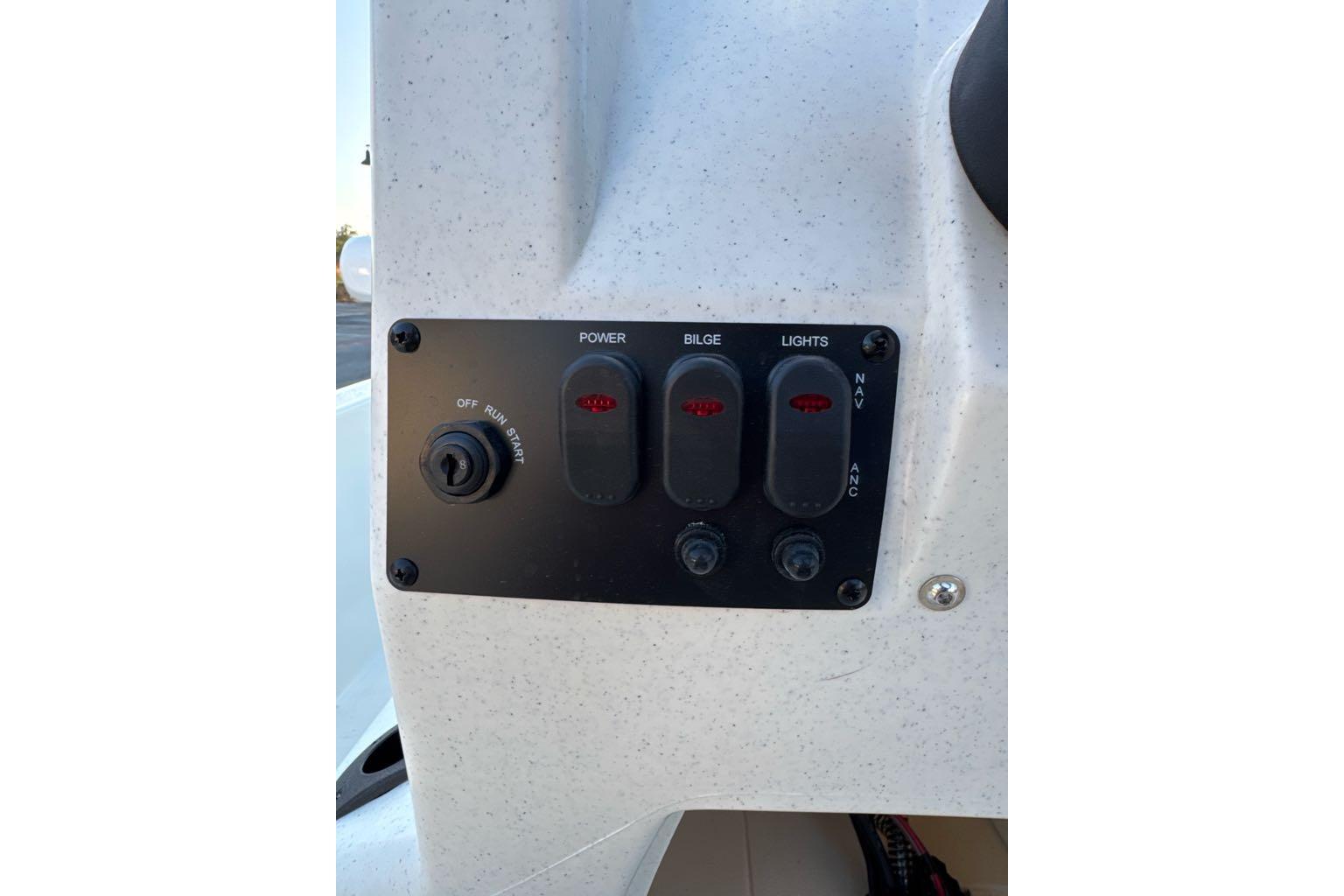 Control panel of 2026 Mako Pro Skiff 13 CC boat with switches and ignition.