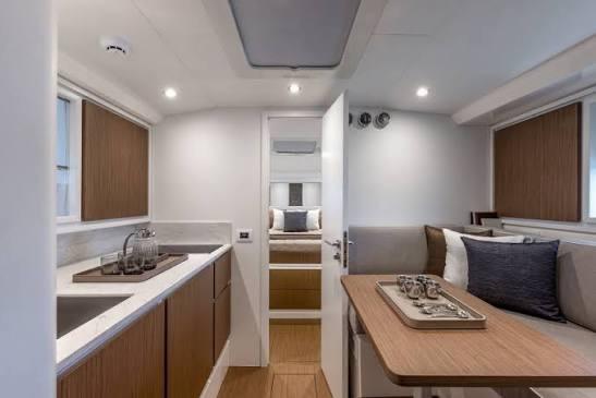 Luxurious interior of 2023 Itama 45RS yacht featuring modern kitchen and cozy seating area.