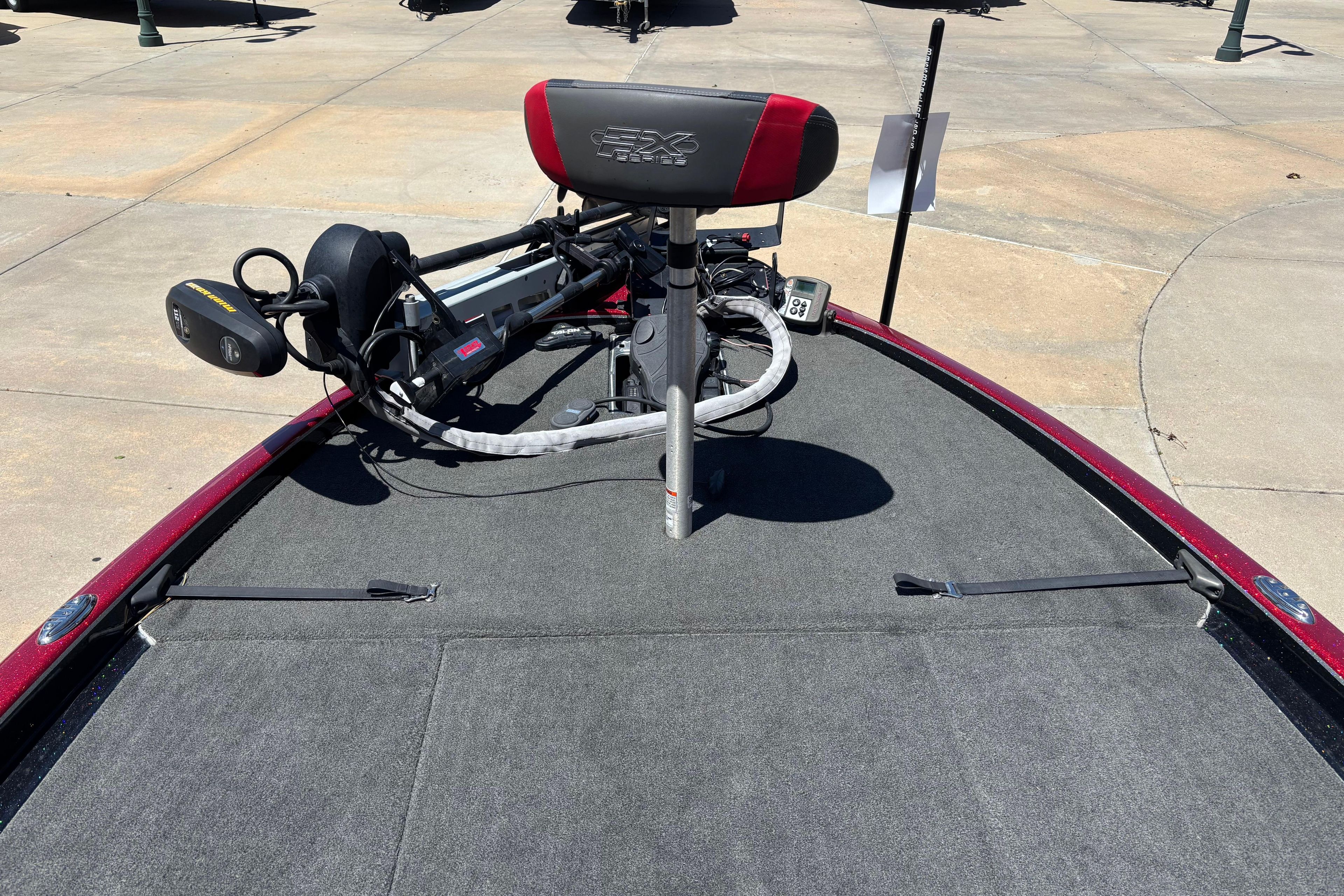 2017 Skeeter FX21 boat deck with trolling motor and seat, parked on concrete surface.