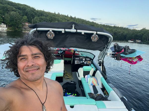 Man on 2022 MasterCraft NXT22 boat, enjoying a day on the lake.